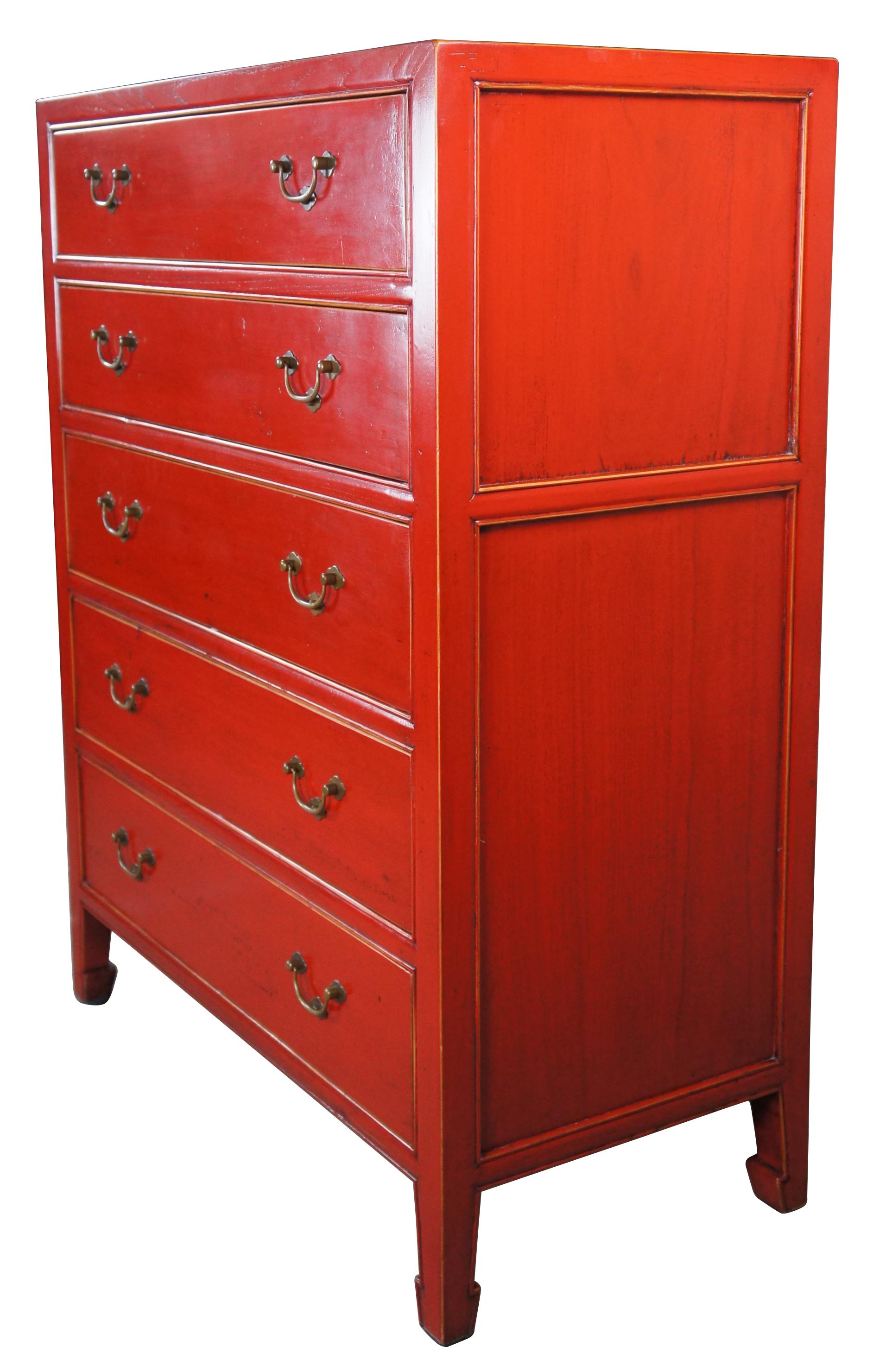 An impressive modern chinese red lacquer dresser, circa last half 20th century. Made from elm with classic Ming styling. Features 5 dovetailed drawers with brass bail hardware over tapered legs. With its vivid red color and natural wood undertones