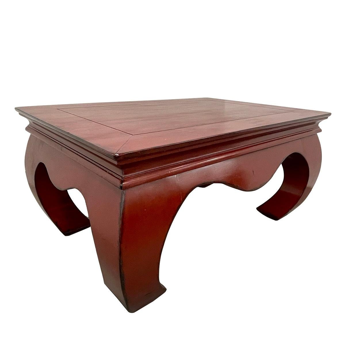 This Massive Chinese Ming Dynasty style coffee table was made from solid elm wood with red lacquer finish. It has narrow carved waist and four huge banana legs which is typical Ming dynasty style. It is heavy and sturdy. Very smooth to touch and