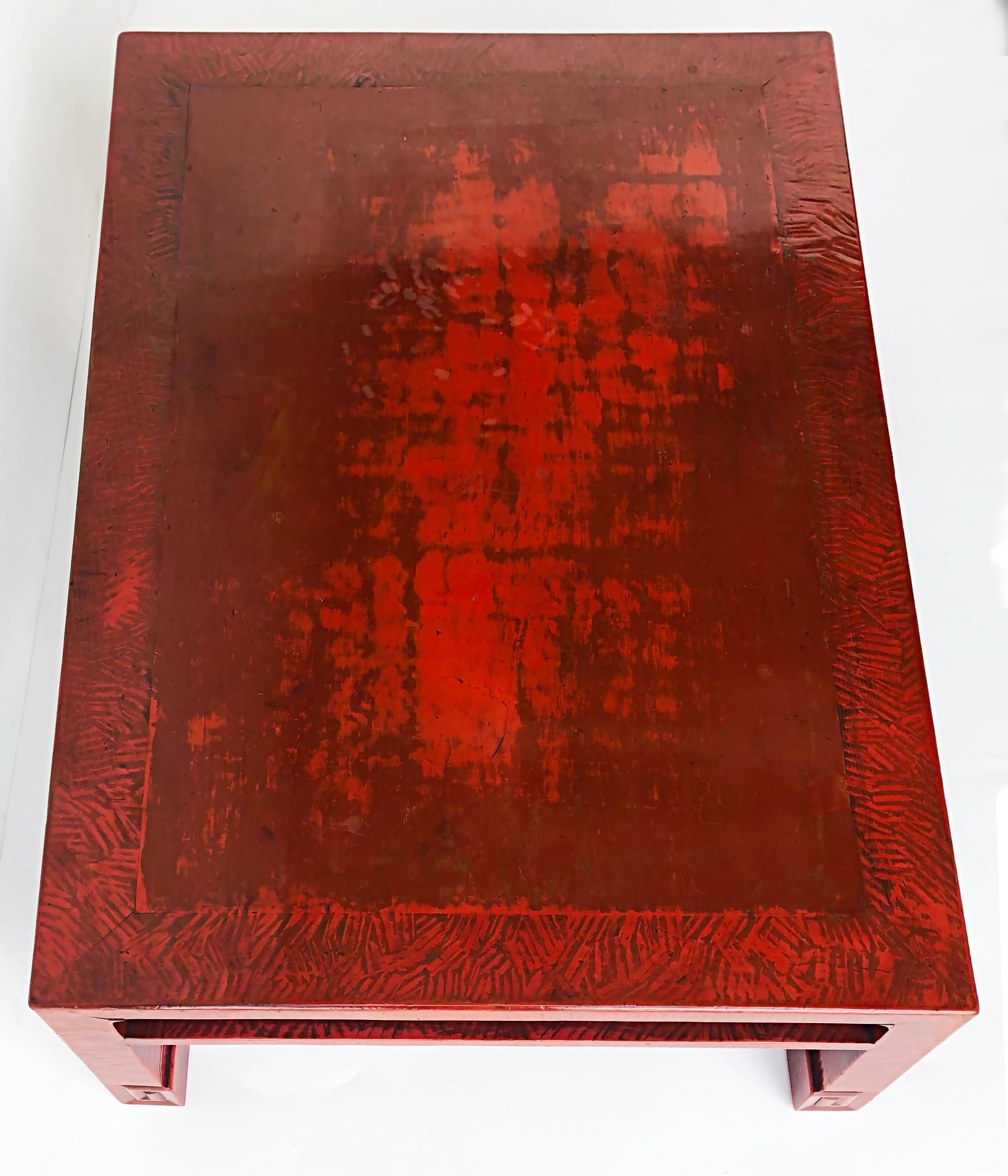 Vintage Chinese red lacquered rectangular coffee table

Offered for sale is a striking vintage Chinese coffee table that is created in a 2-tone red lacquer finish with some light built-up textures of the finish materials. The table has legs with