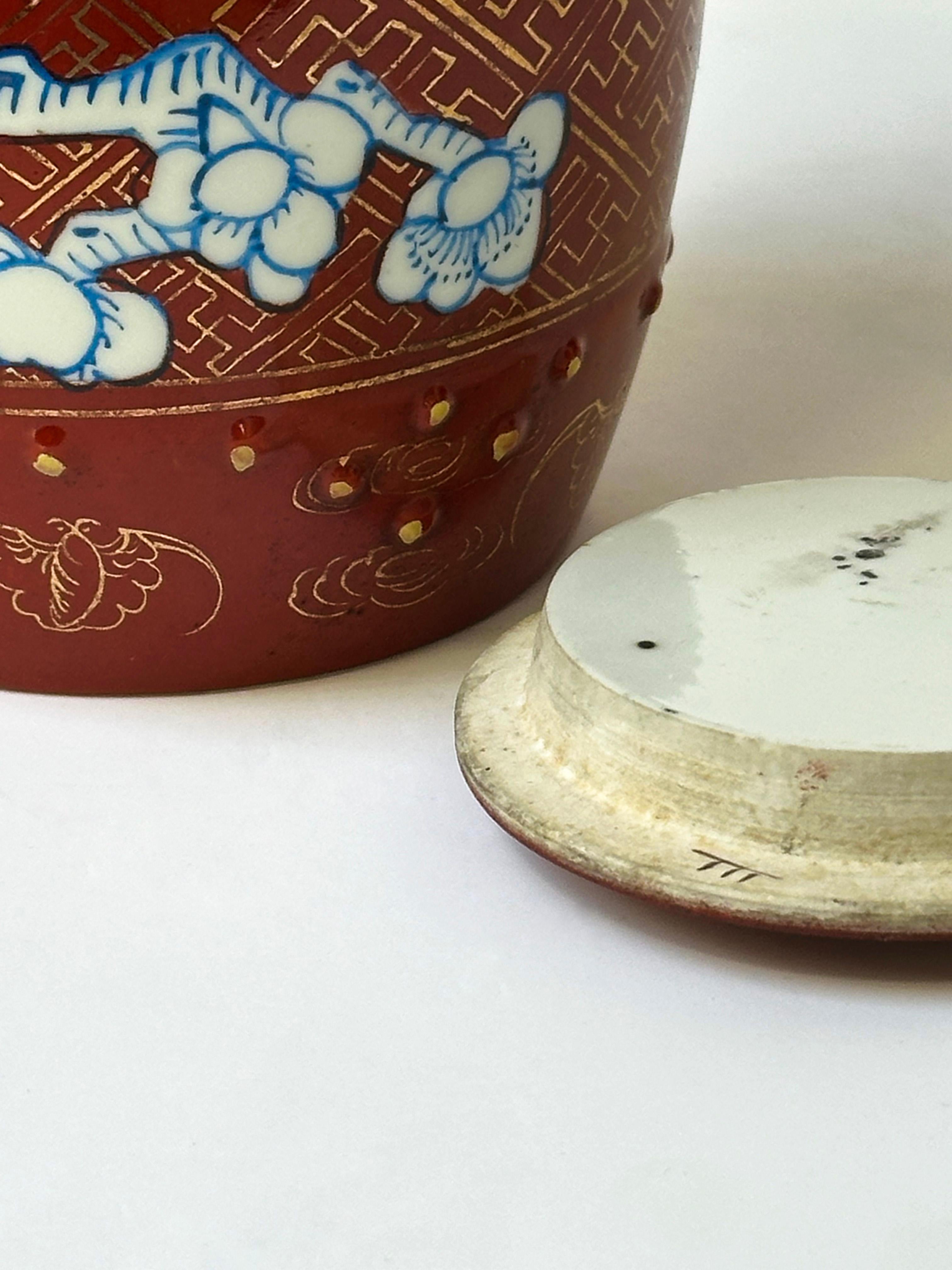 A vintage Japanese ginger jar, hand-glazed and adorned with a ‘prunus’ illustration in vibrant blue. The body of the caddy is glazed in deep red, and atop is delicate design of hand painted pure gold lines 

The choice of colours and the meticulous