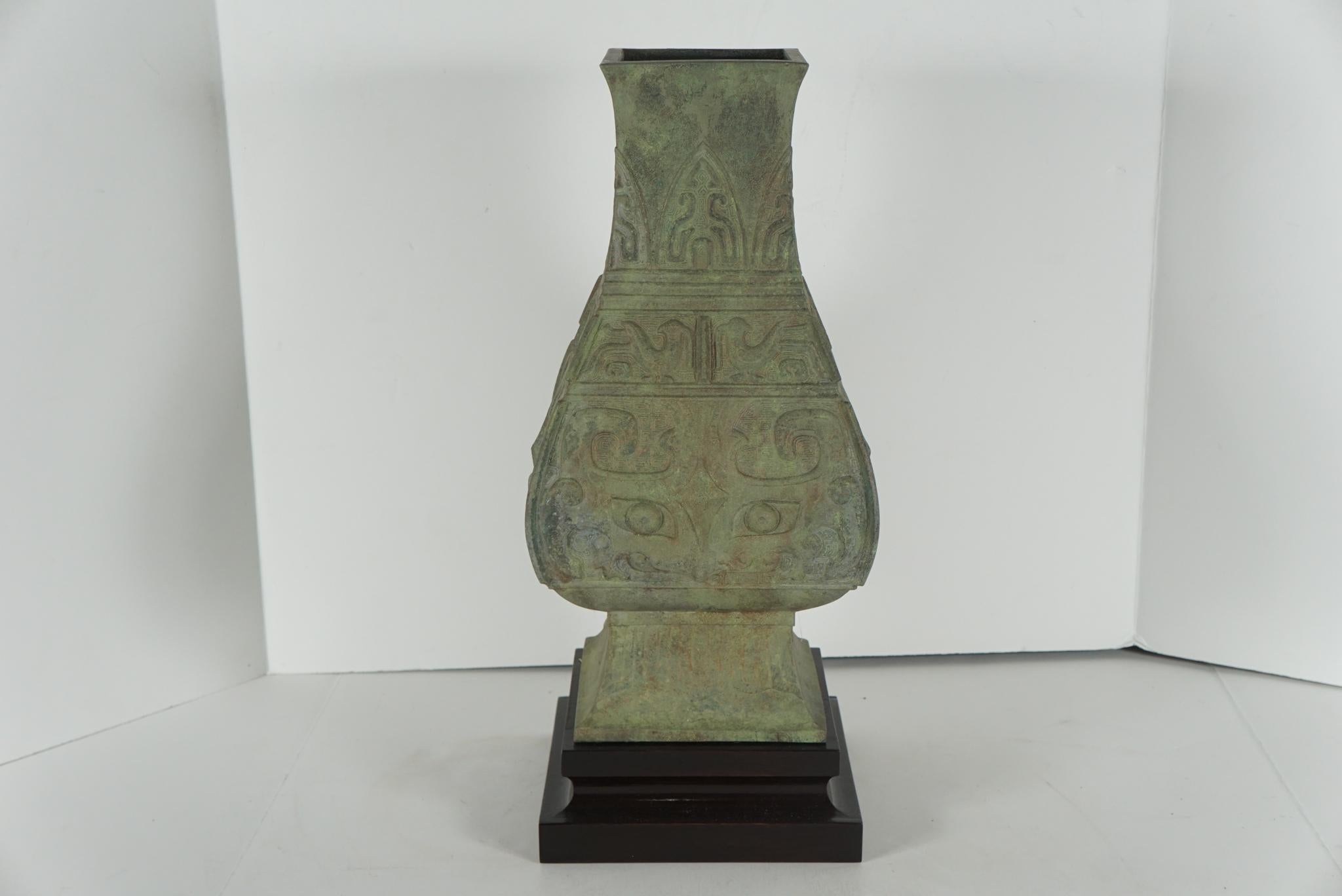 This archaistic Hu form bronze vessel was made in the Republic period just following the end of Chinese Imperial rule. Cast as an honorific venerable object by workers still in possession of ideals from the imperial times. This period shows the