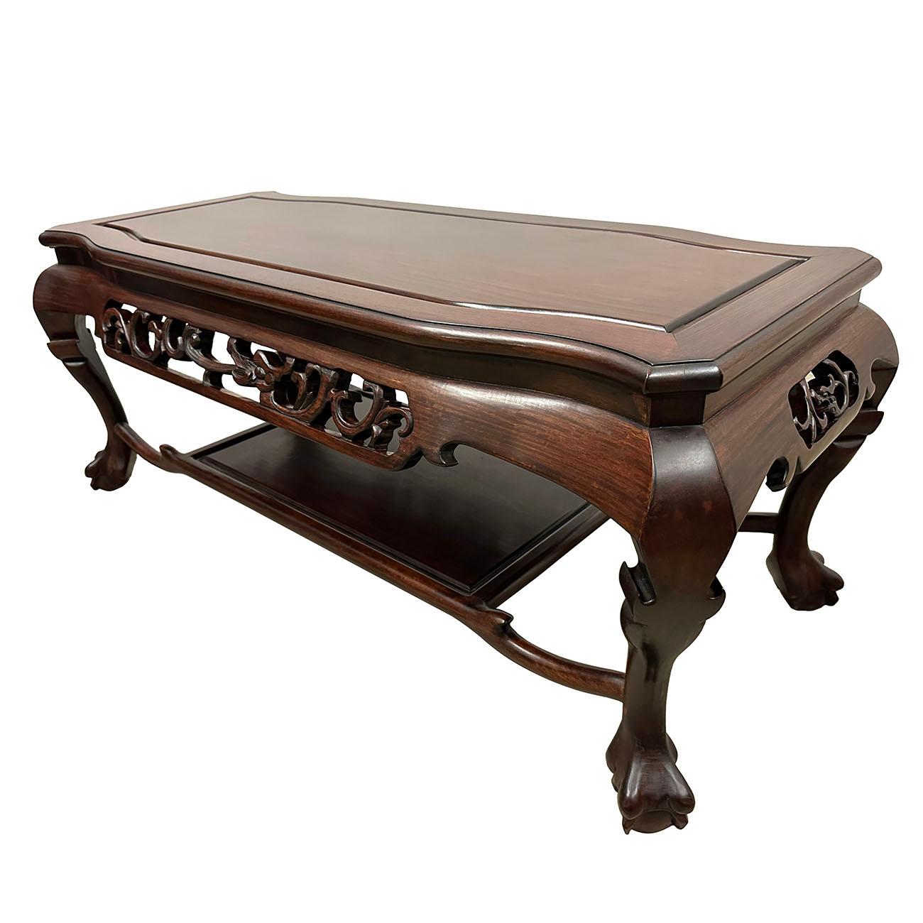 

This Chinese classic solid rosewood coffee table is laced with hand-carved dragon motif along the four sides of the apron. The curved legs ending on the tiger-paw feet give a graceful and also sturdy look. A shelf underneath gives you a extra