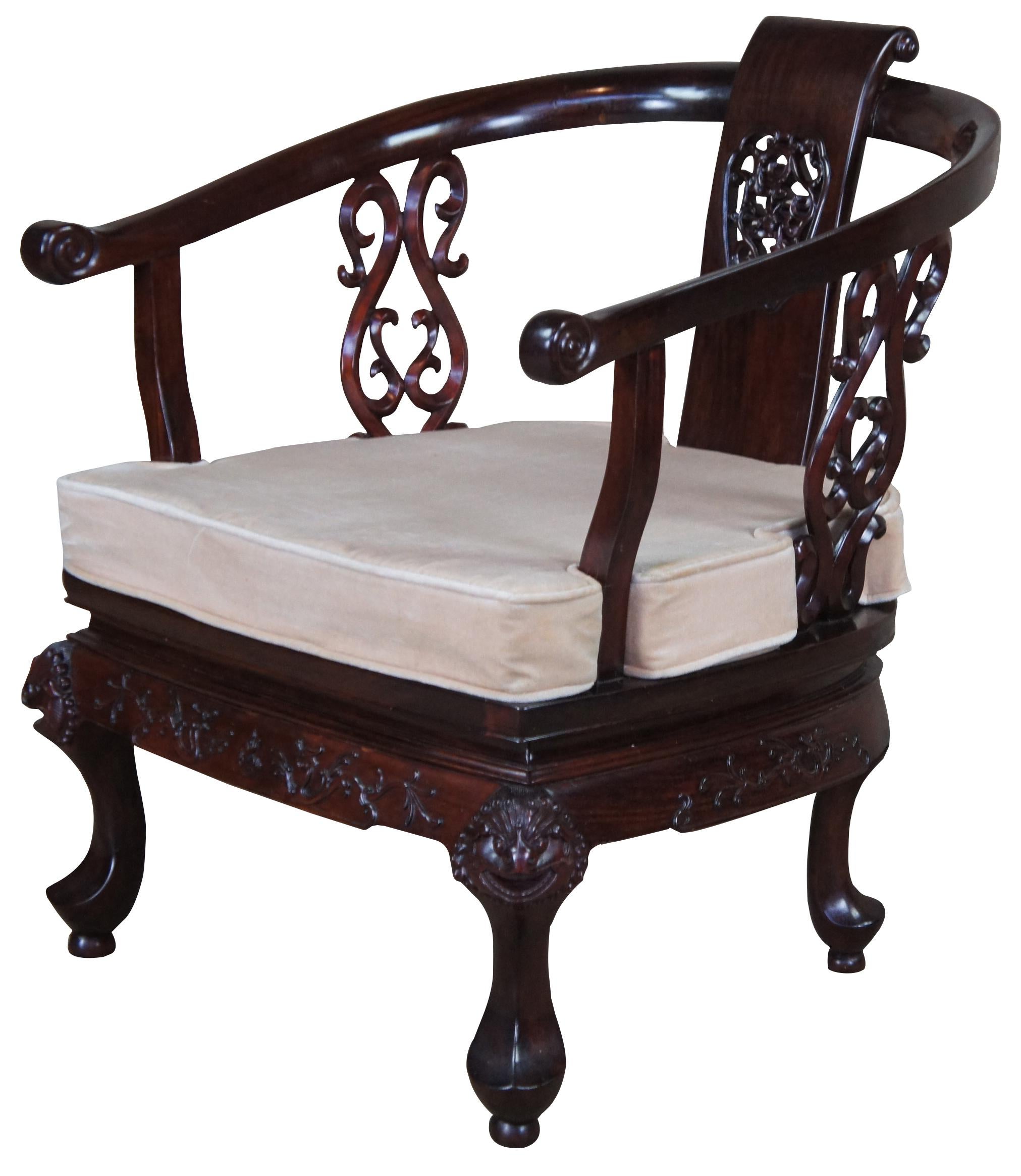 Vintage Chinese horse shoe or yoke arm chair. Made of Rosewood featuring piereced splat, ornate supports, figural carved animal faces and serpent accents.
     