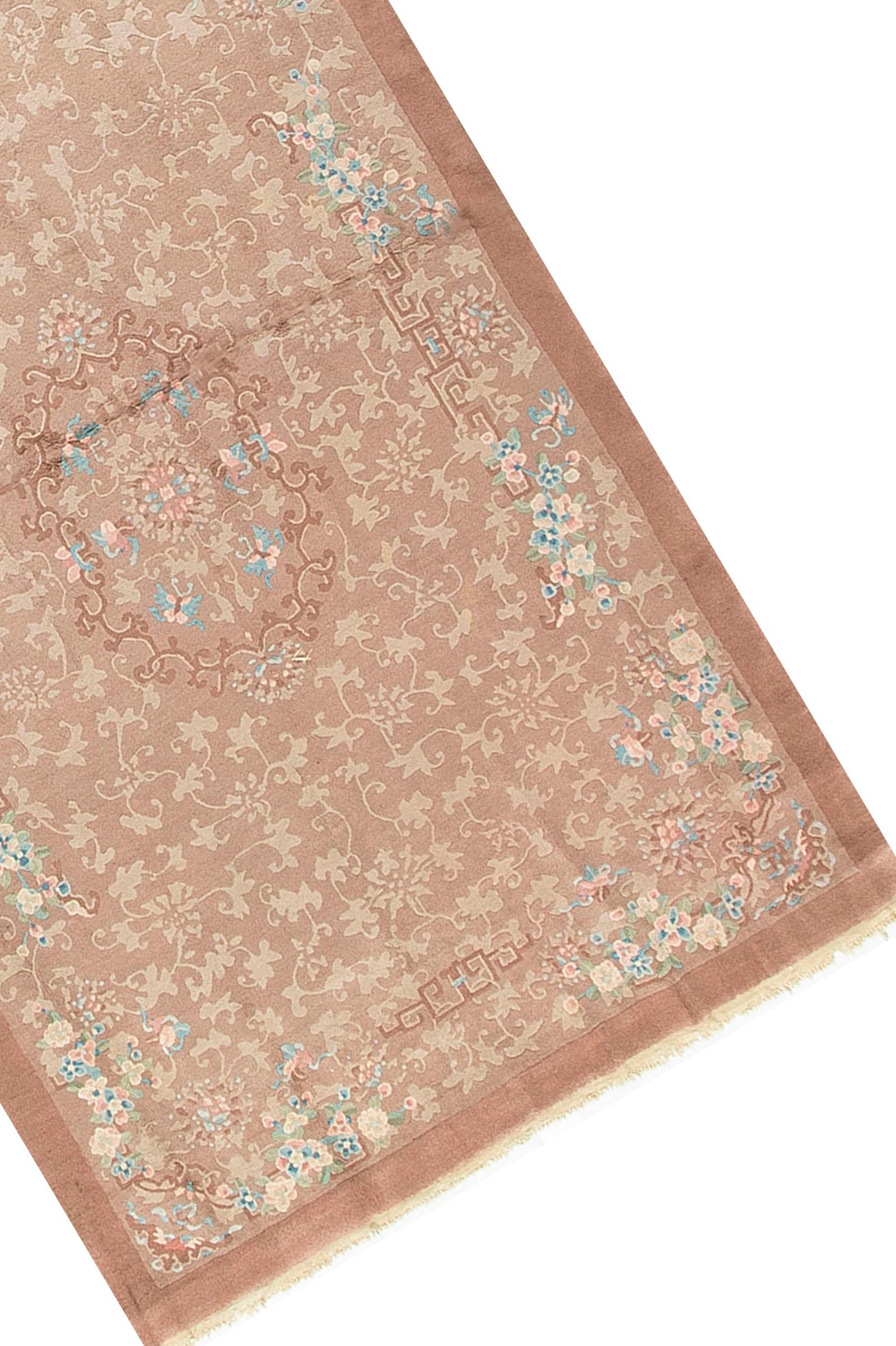 Vintage Chinese rug, circa 1940.Chinese handwoven rug with a soft peach ground, the corner spandrels with a floral design matching the central motif, this theme is expanded into the two main borders in a light and slightly darker shade to give the