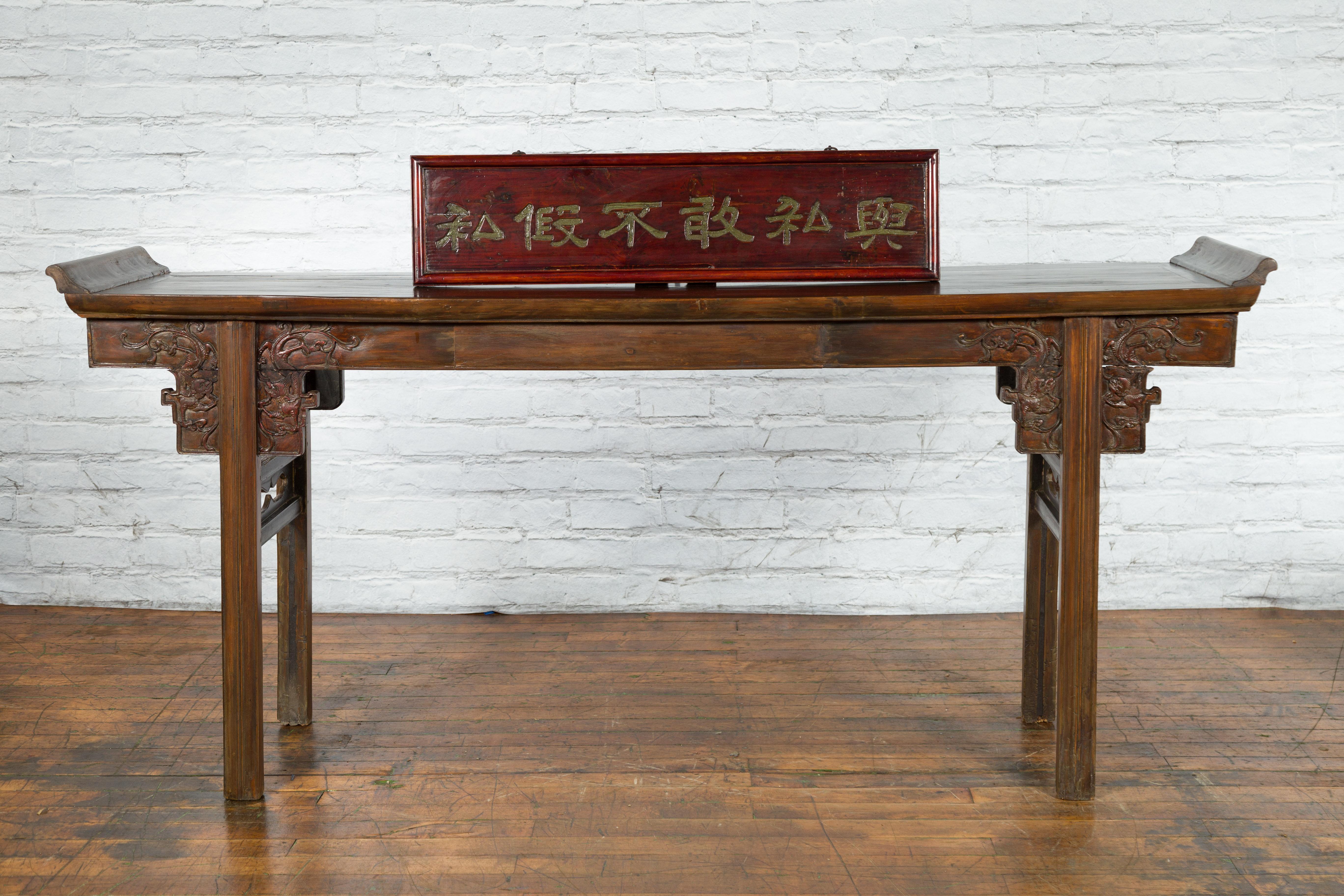 A vintage Chinese horizontal shop sign from the mid 20th century with lacquered finish, carved and gilt calligraphy. Created in China during the midcentury period, this horizontal shop sign features an outer molded frame surrounding a beautiful