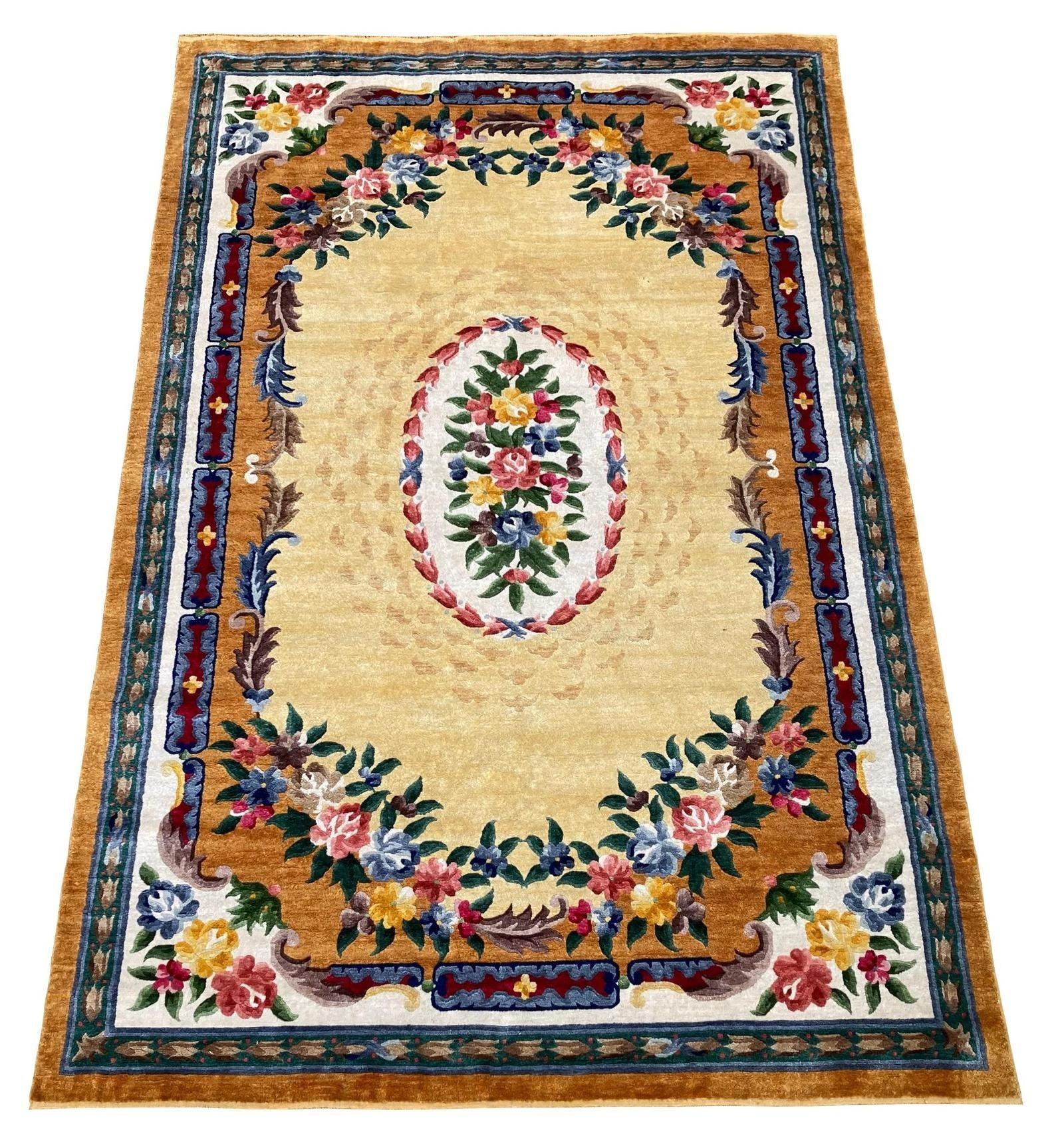 An unusual vintage silk carpet, hand woven in China circa 1950 with a floral Aubusson design on a lemon field and eye catching secondary colours. Note the interesting plaited gold silk fringes. This carpet would have predated the commercial weavings