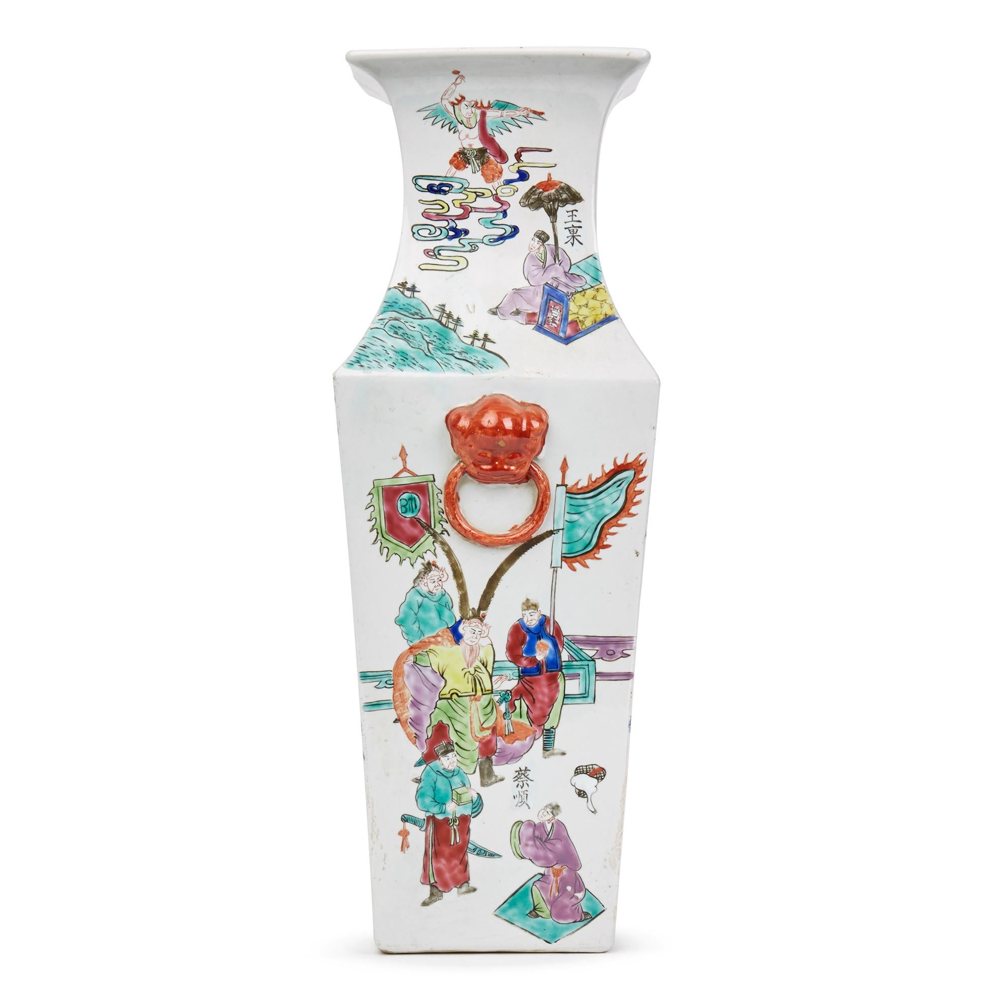 A fine antique/vintage Chinese porcelain square form vase hand decorated with various scenes in the famille rose palette with dog and ring handles applied to the side. The four sided tall vase has a shaped top with each panel painted with a figural