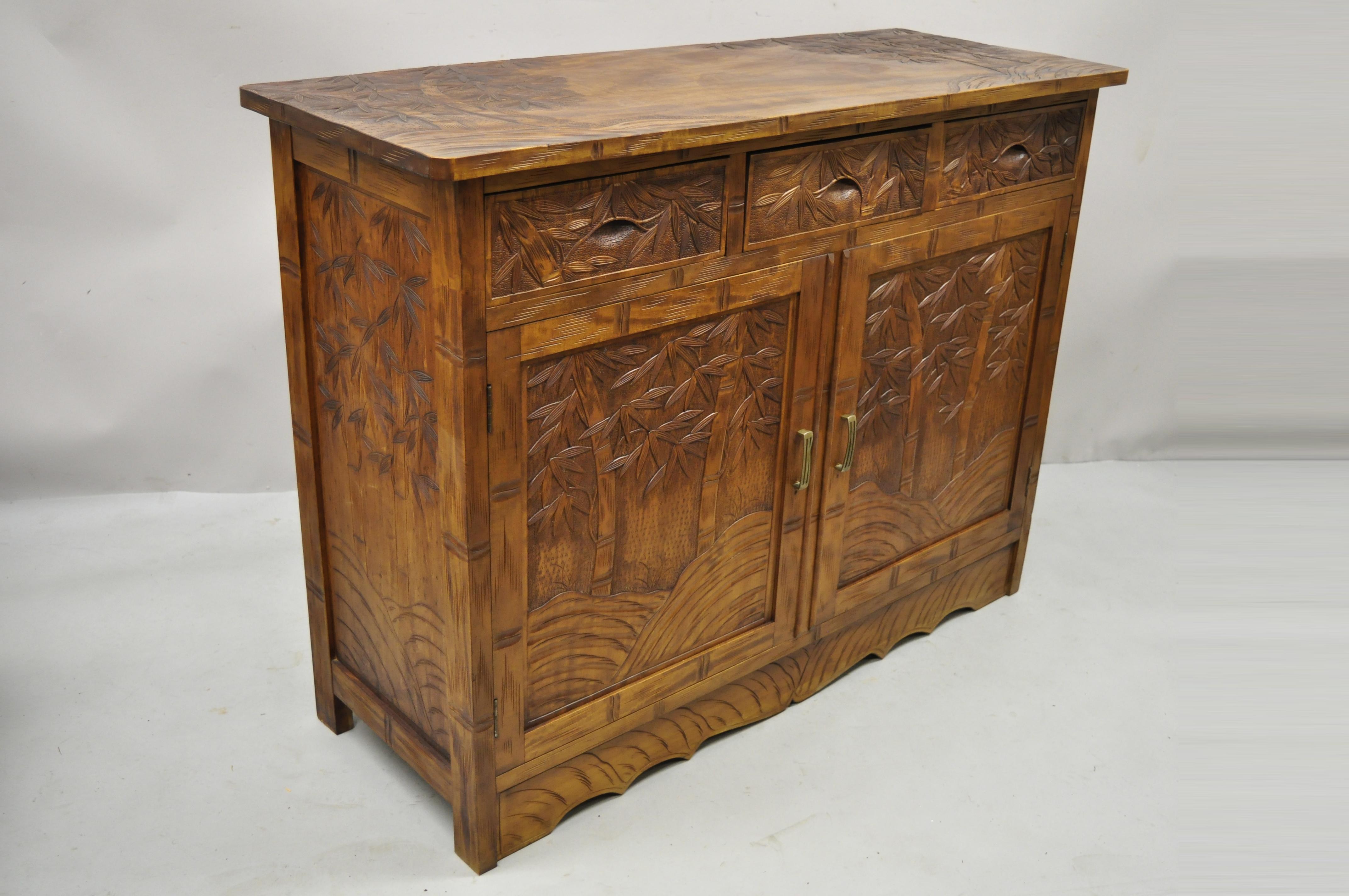 Vintage Chinese teak wood carved bamboo tree sideboard buffet cabinet. Item features carved wood bamboo tree raised panel design to fronts, sides, and top, solid wood construction, beautiful wood grain, 2 swing doors, 3 drawers, very nice vintage