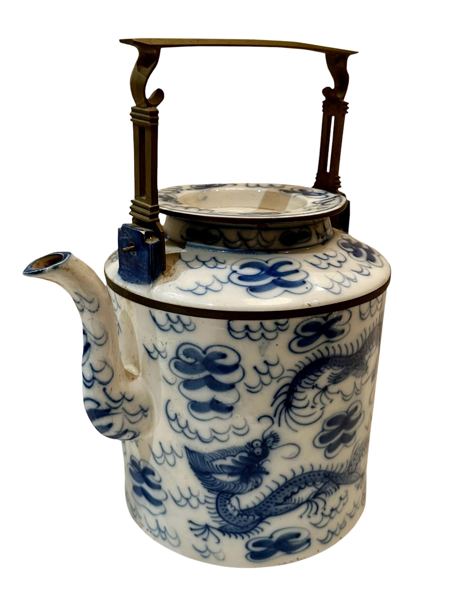 A vintage Chinese teapot very high-quality. Blue and white, depicting clouds and dragons. 
