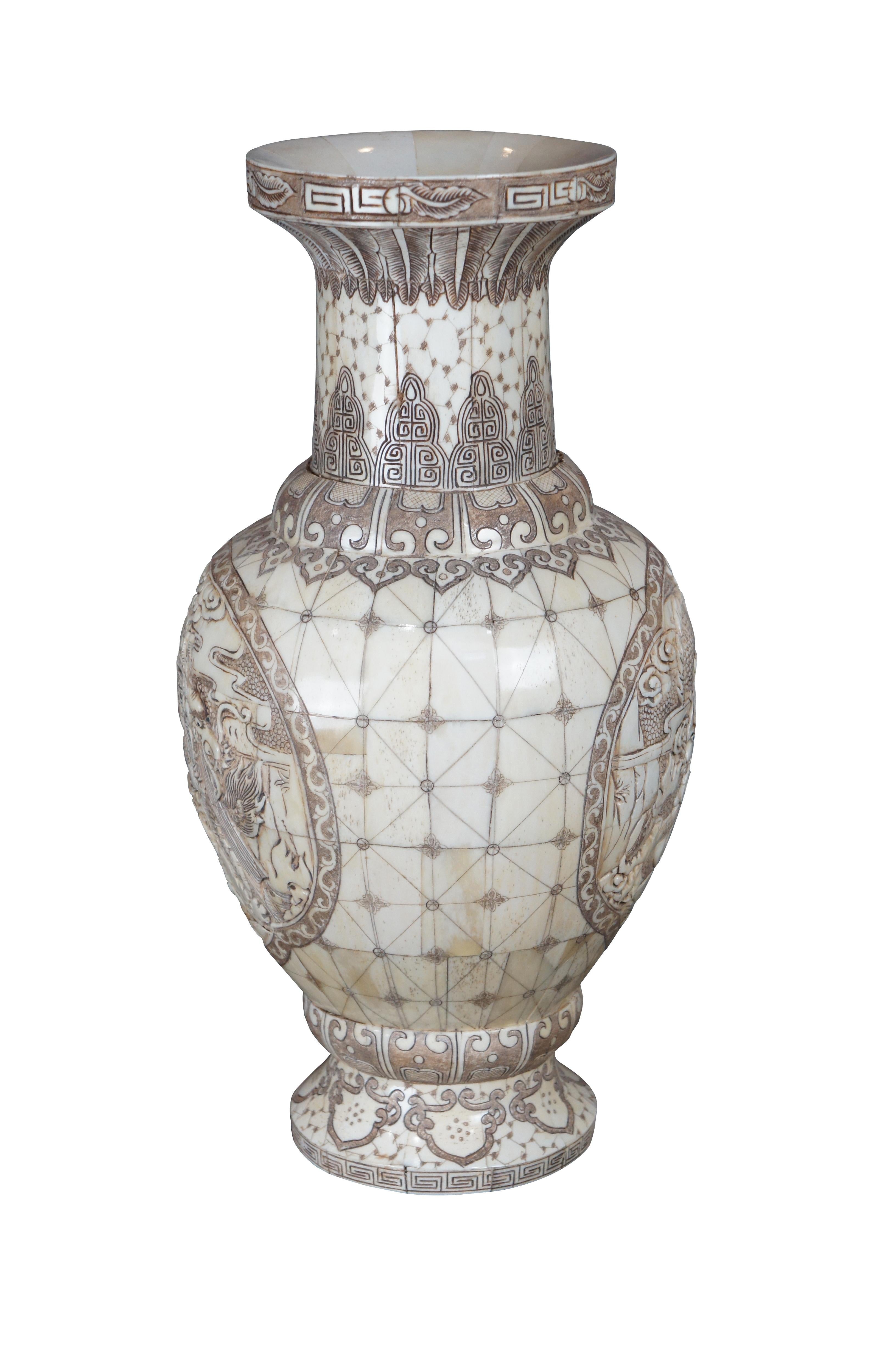An intriguing Chinese 20th century cow bone veneered vase or bottle. Features a tessellated frame decorated on each side with to gnarling dragons and incised Chinese motifs.

Dimensions:
17.25