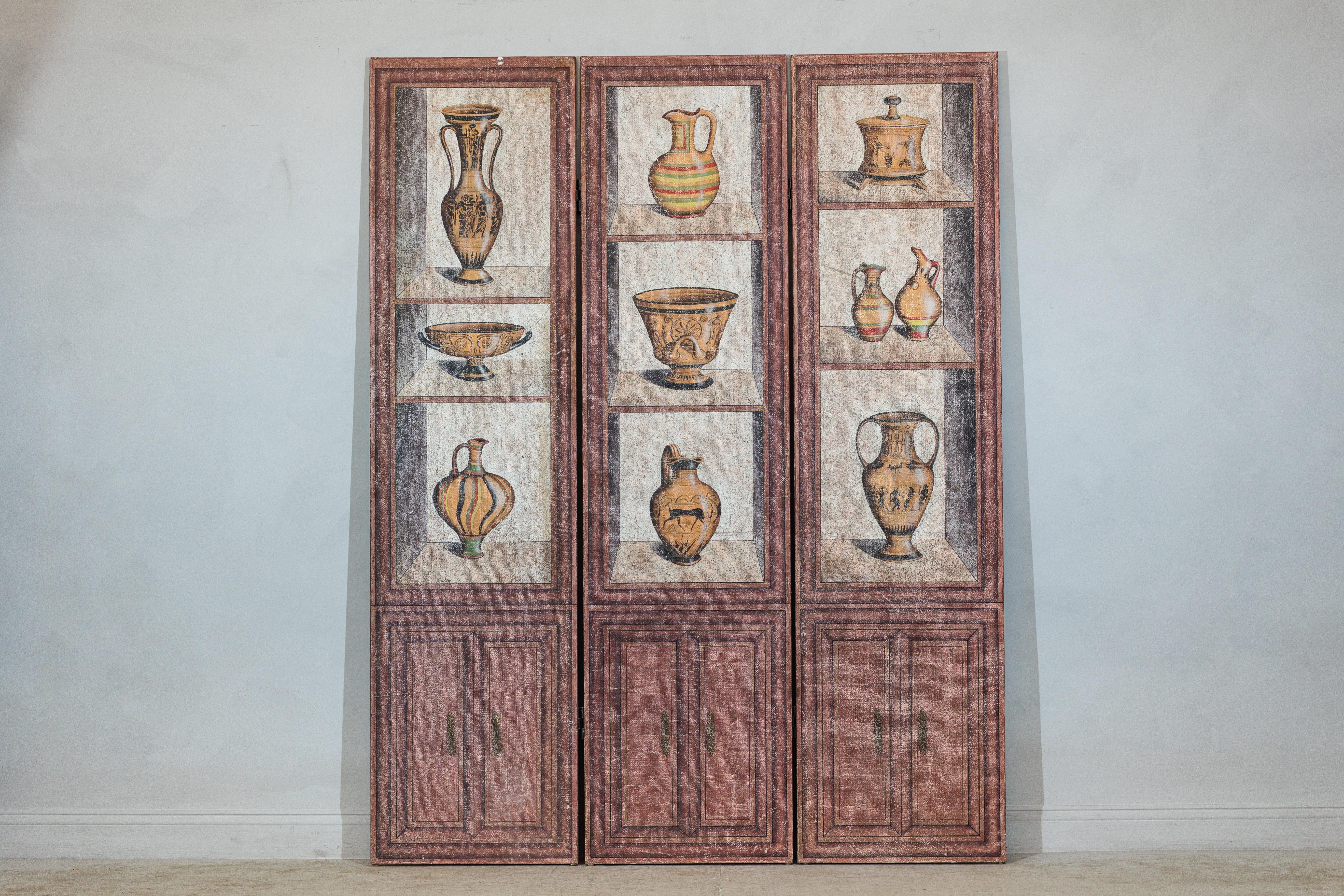 A vintage Chinese three-panel screen, designed with a trompe-l’œil effect that depicts shelves of classical vessels in the manner of an antiquities display. Each panel is hand-painted with amphorae, kraters, and other ancient-style ceramics,