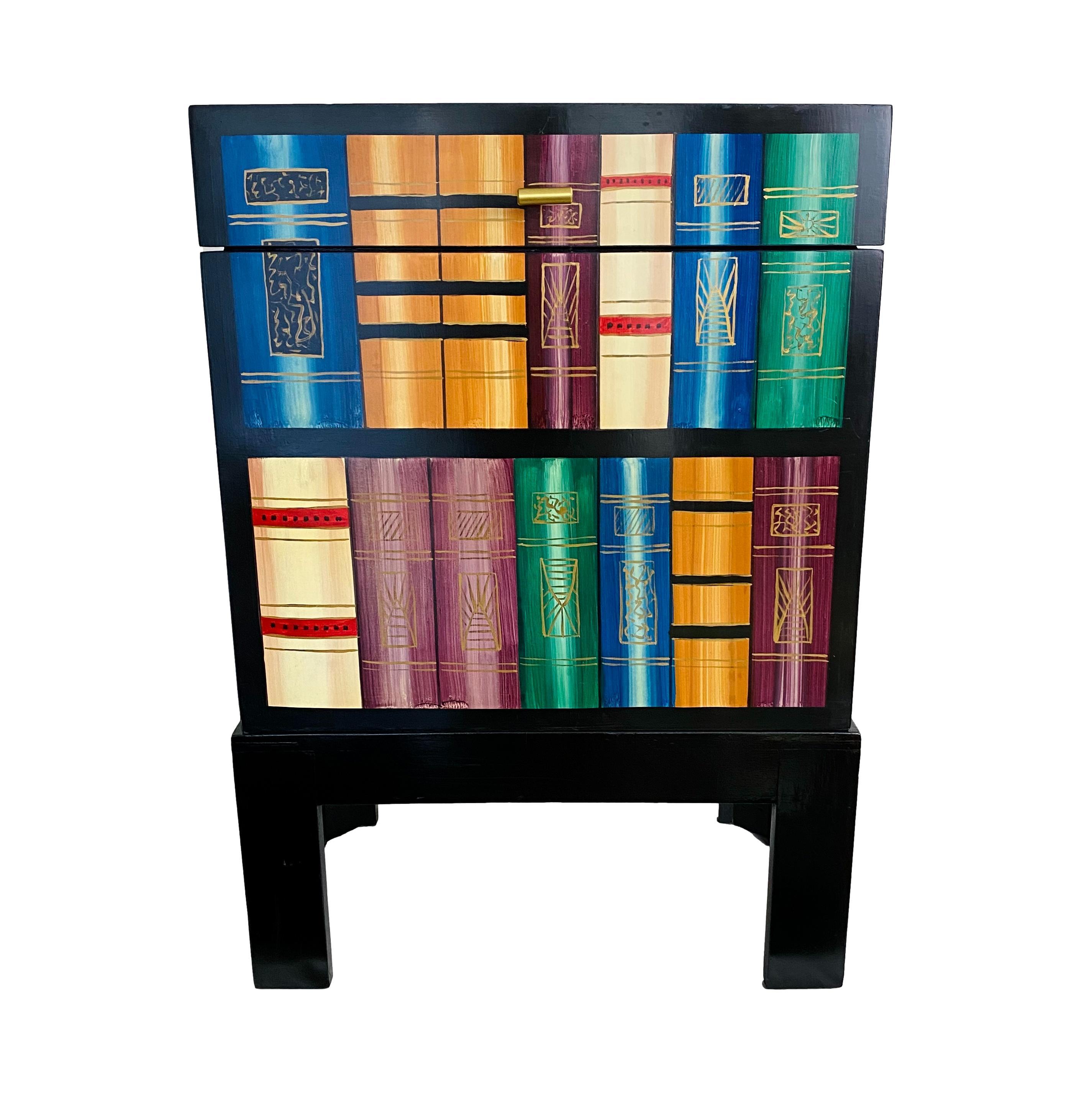 An eclectic vintage Chinese trompe l'Oeil bookcase storage chest on Ming style stand (2 pieces). Black lacquered wood with hand painted 'shelved' book motif. Lined with chinoiserie bird print fabric.

Dimensions: 21