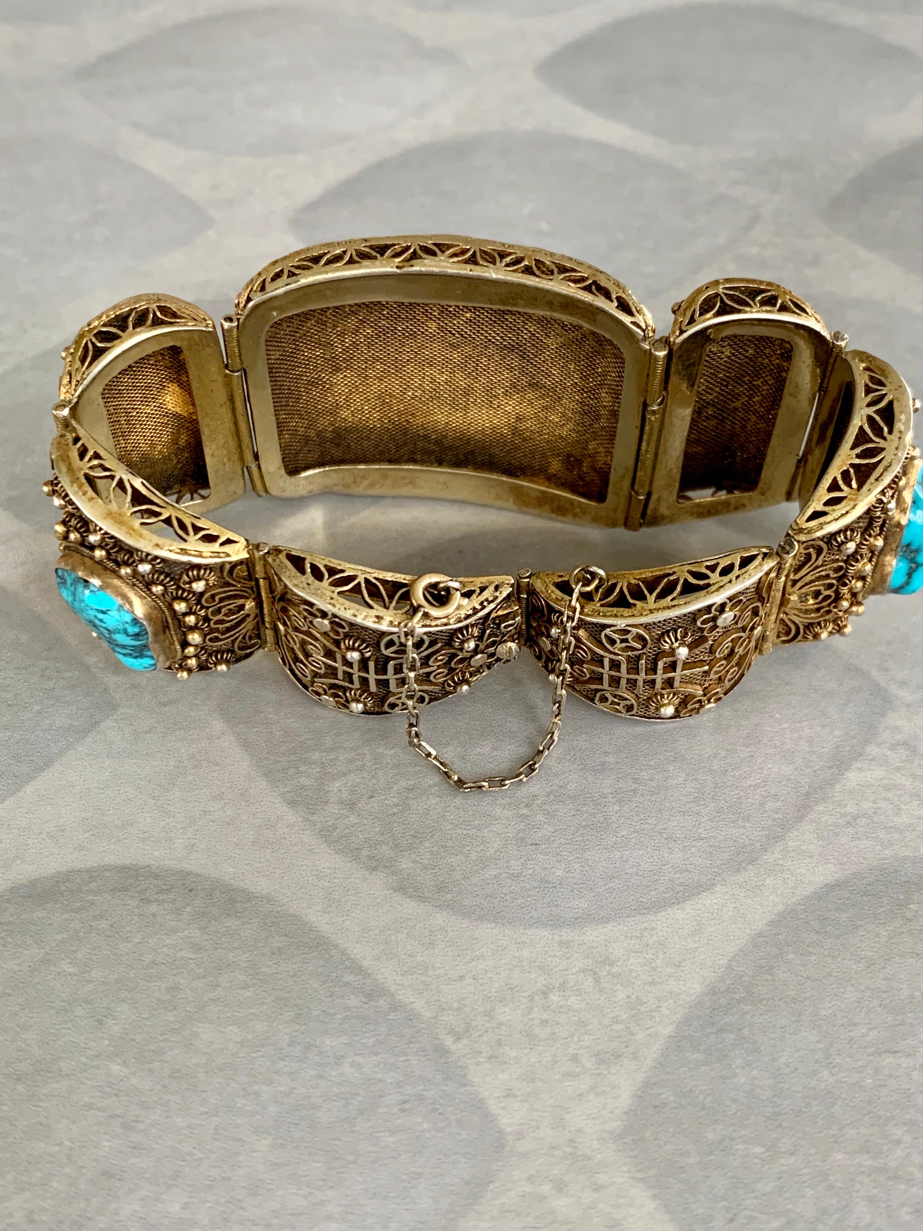 This bracelet is absolutely incredible.  It features seven sections hinged together; five of which have a beautifully veined turquoise stone. The bracelet is Silver which has a Gold wash over it.  The workmanship is very intricate.

Size: 7