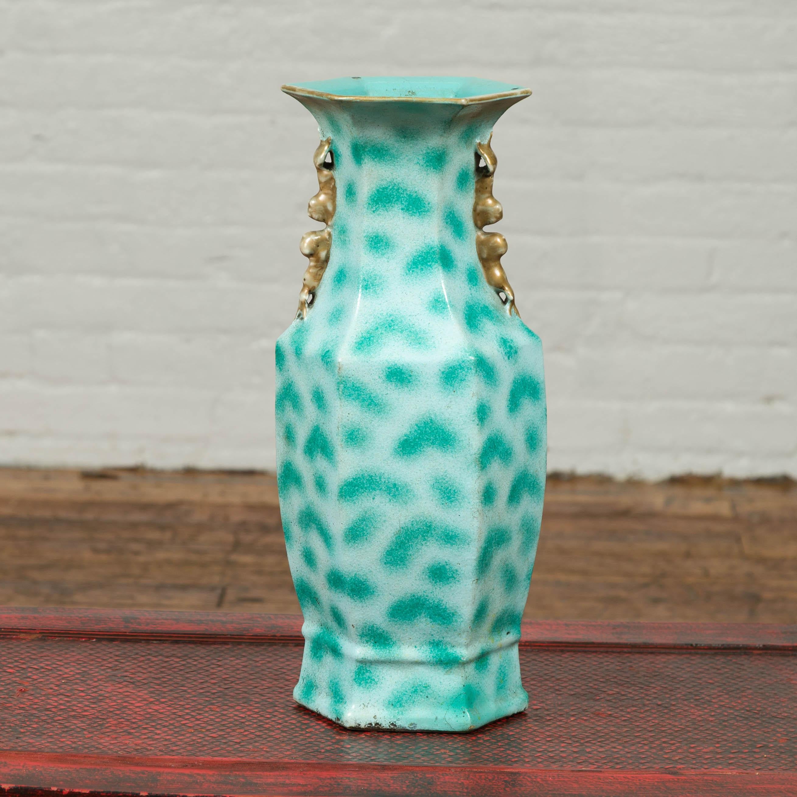 A vintage Chinese turquoise color vase from the mid-20th century, with spotted design and tiny handles. Born in China during the mid-20th century, this vase attracts our attention with its turquoise color and spotted motifs. Topped with a hexagonal
