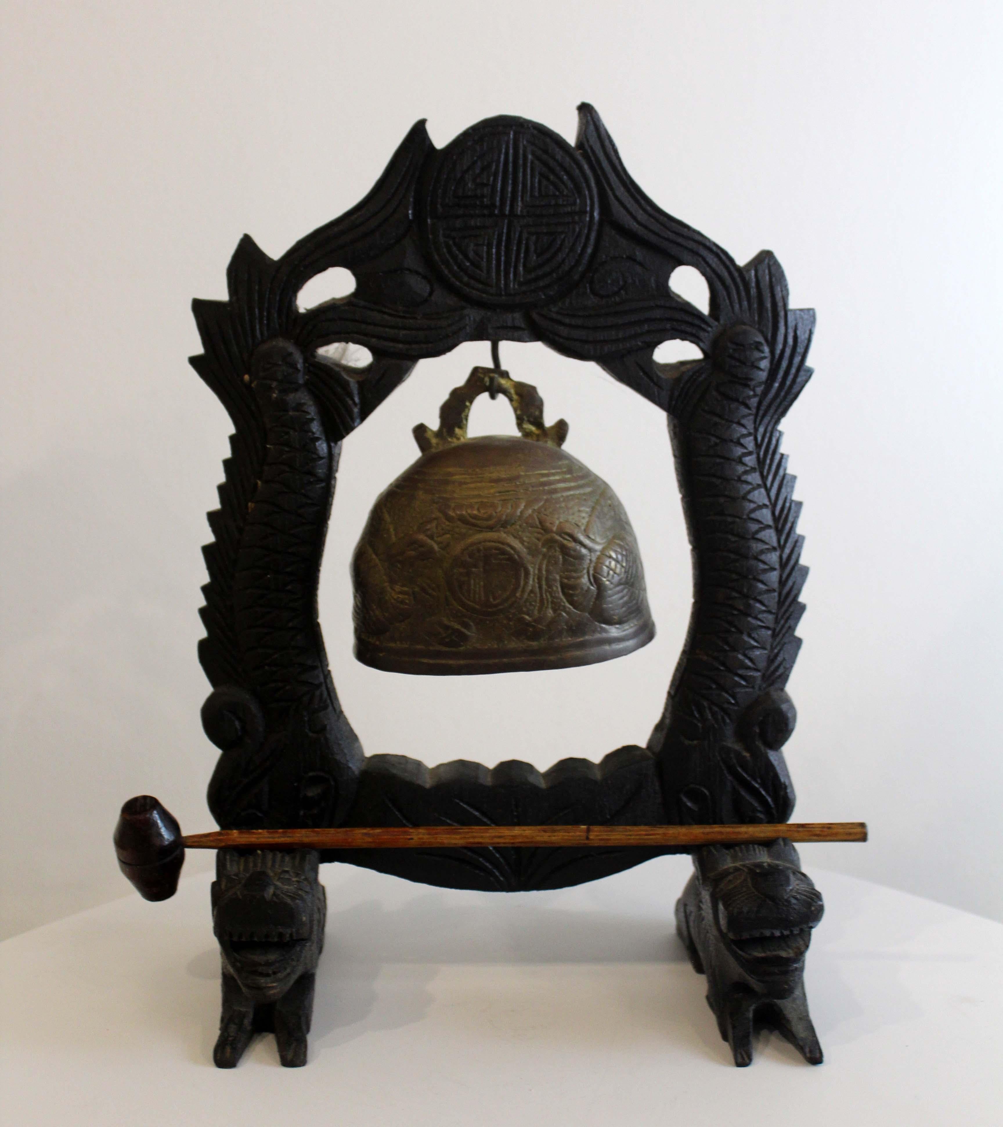 A fascinating vintage Chinese wood and brass gong bell. Carved and engraved details make this a showstopping collector’s time. Includes gong to ring bell. Original item from the 20th century. From a private collection. Dimensions: 12.75 H x 8.5 W x