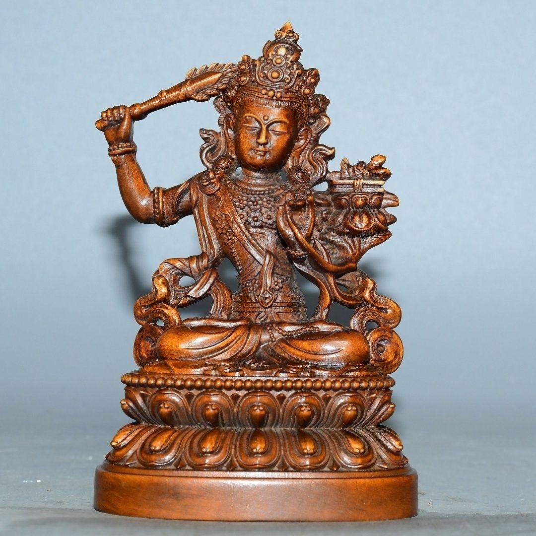 This Vintage Chinese Wooden Carved Statue of Manjushri Bodhisattva is an exquisite representation of wisdom, clarity, and compassion. Manjushri, known as the Bodhisattva of wisdom in Mahayana Buddhism, is depicted here in intricate detail, embodying