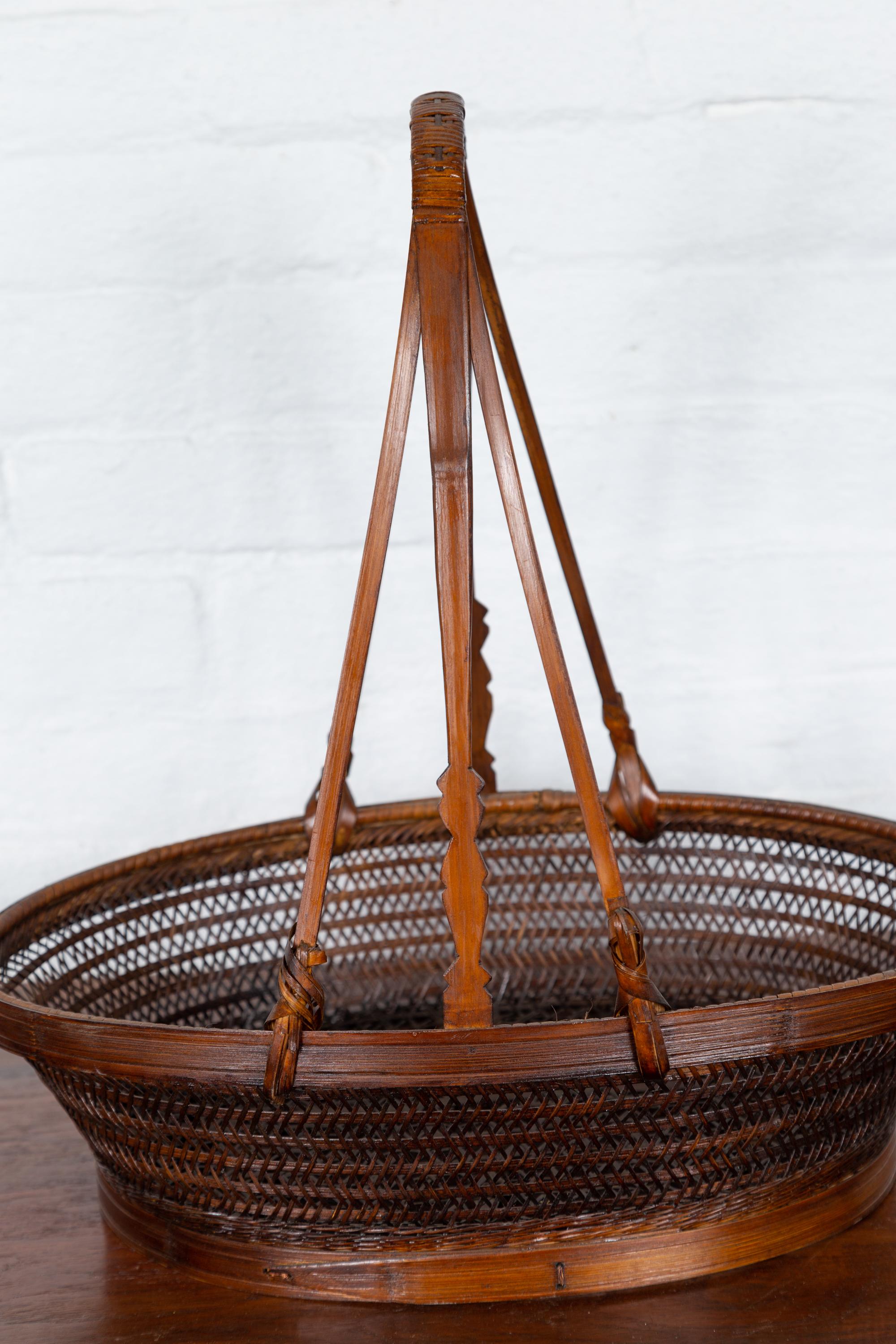 Rustic Vintage Woven Rattan Carrying Basket with Large Tripartite Handle For Sale