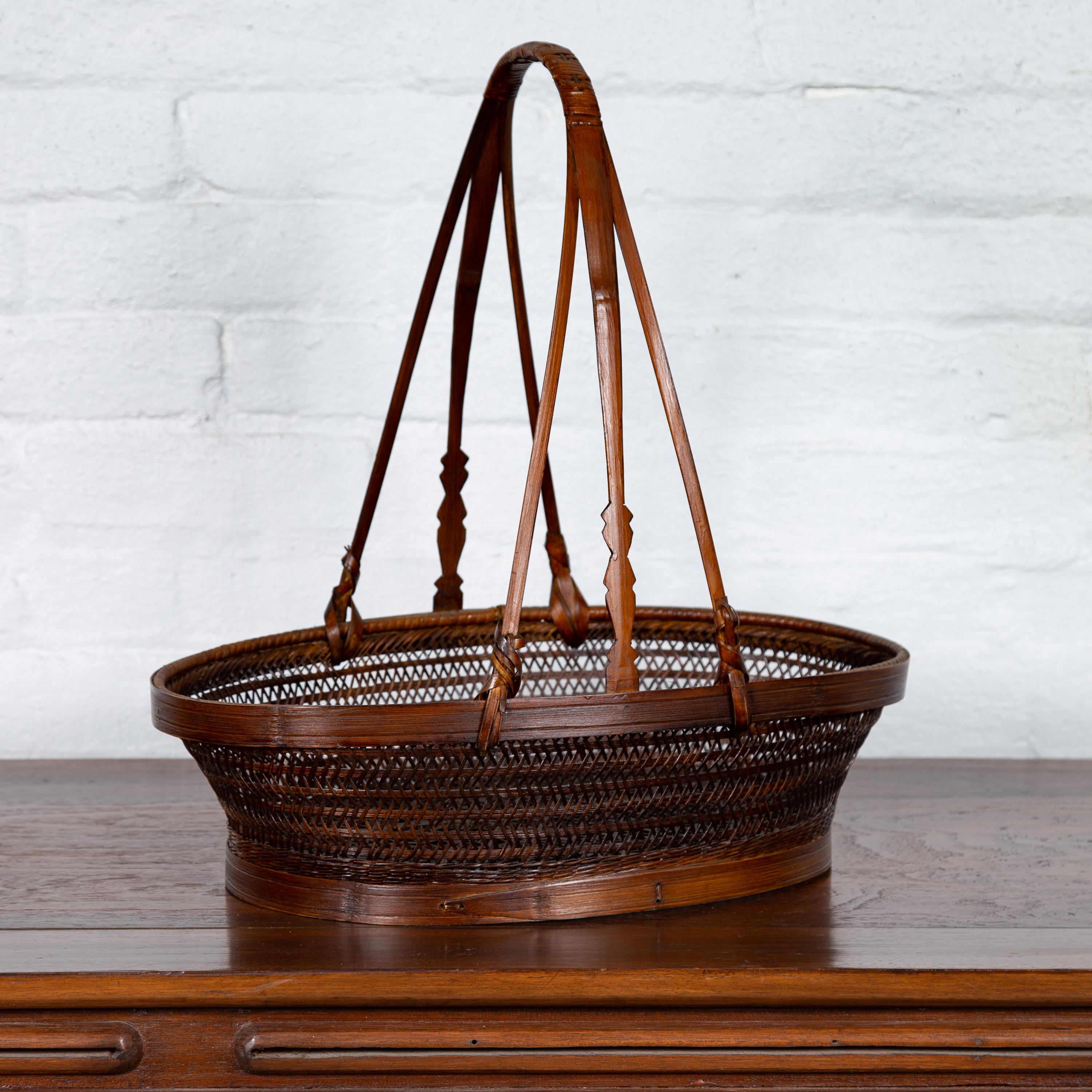 Vintage Woven Rattan Carrying Basket with Large Tripartite Handle In Good Condition For Sale In Yonkers, NY