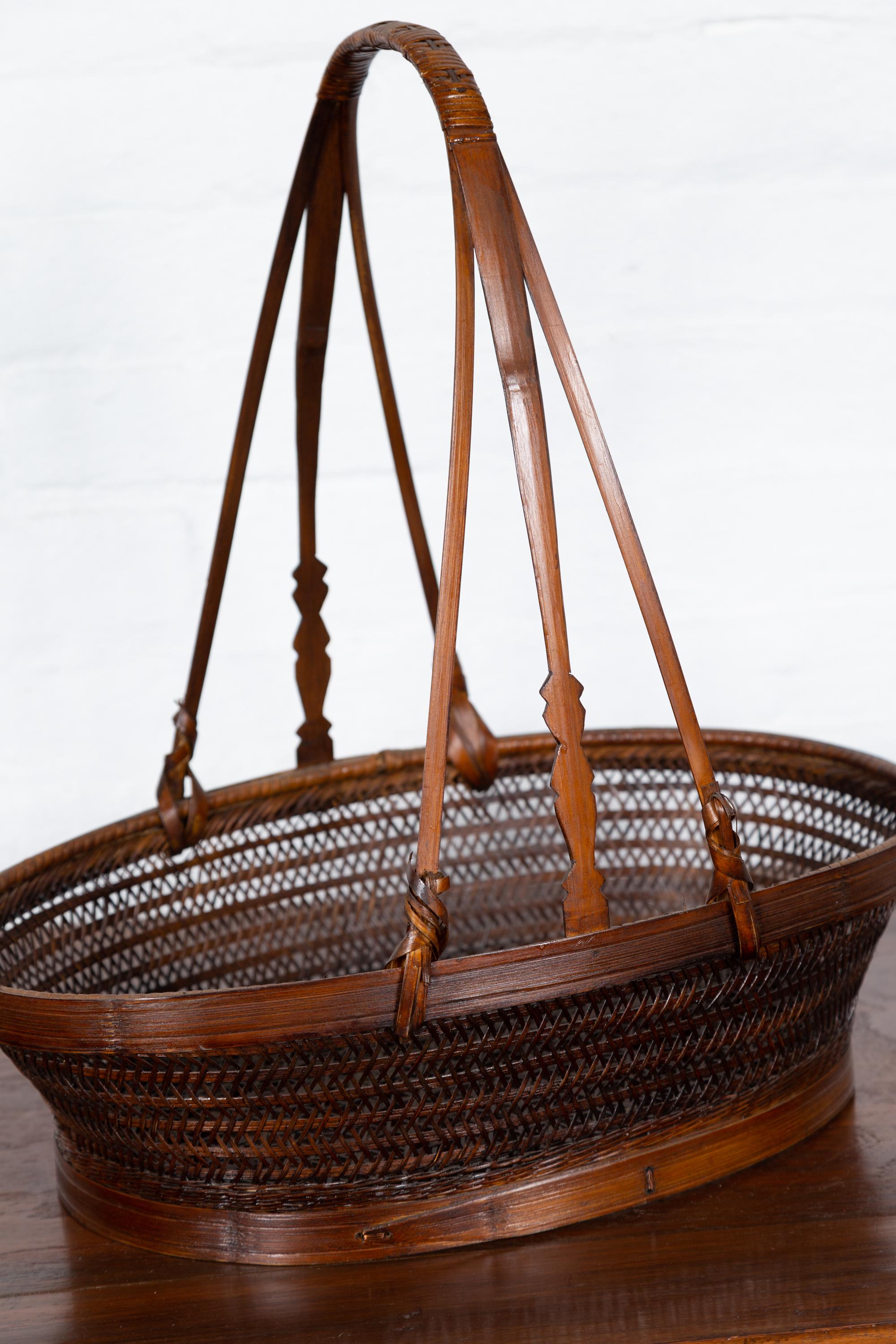 20th Century Vintage Woven Rattan Carrying Basket with Large Tripartite Handle For Sale