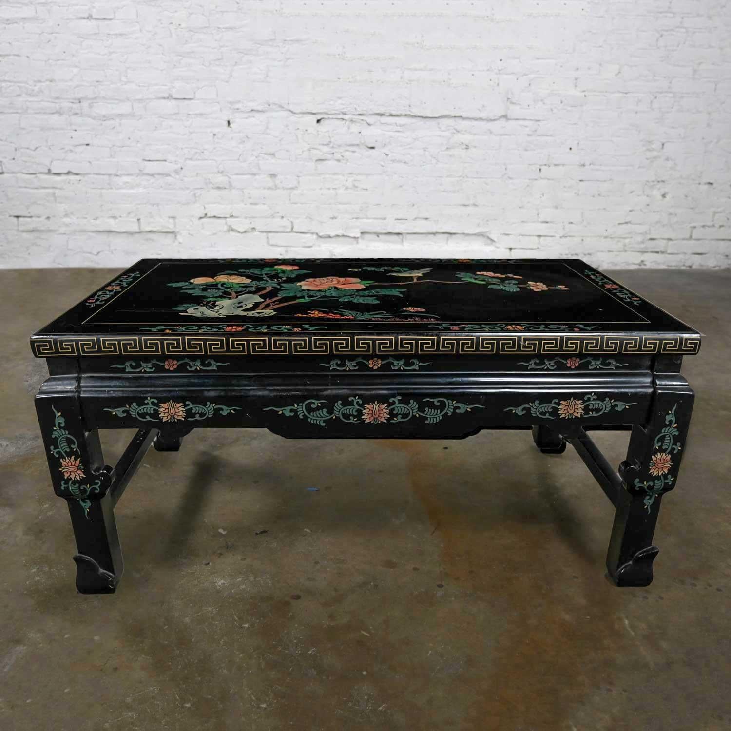 Stunning vintage chinoiserie Asian folding coffee table black lacquered with carved gold meander or Greek key & floral designs and modified Ming chow feet and the skirts and legs fold in. Beautiful condition, keeping in mind that this is vintage and