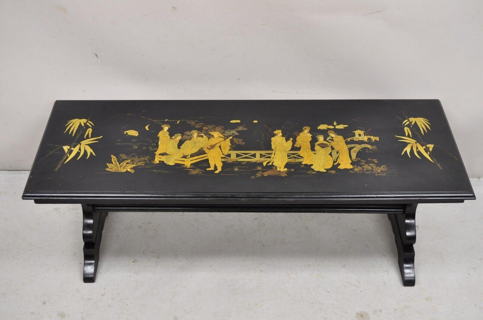 Vintage Chinoiserie Asian Inspired Black Painted Gold Gilt Trestle Base Coffee Table. Circa Early to Mid 20th Century.
Measurements: 17.5