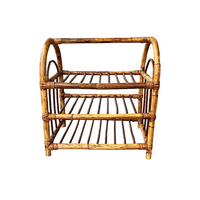 A gorgeous vintage chinoiserie burnt bamboo wine rack. Created from bentwood and rattan, this vintage piece will be a showstopper in a kitchen or butler's pantry. With an arched rounded top, this wine rack has three shelves and will fit 12 bottles