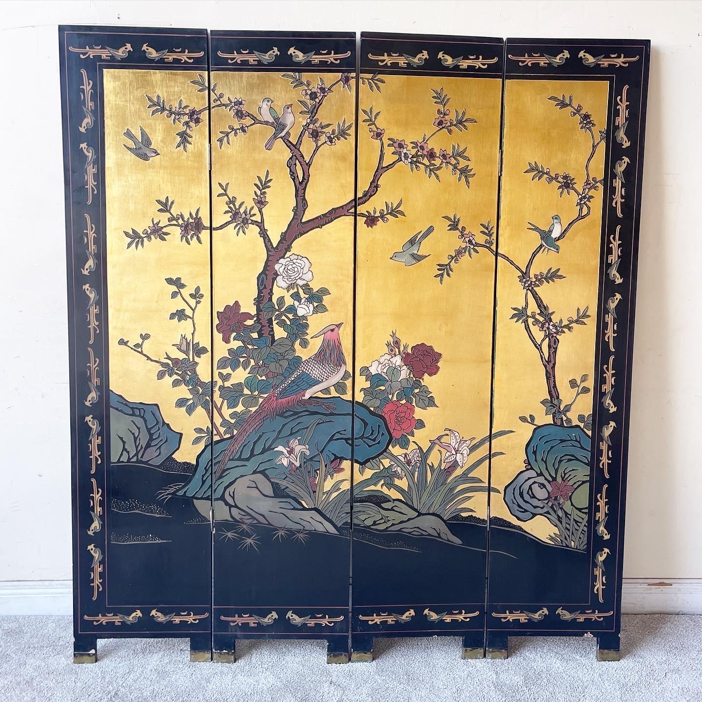 Exceptional vintage chinoiserie 4 paneled room divider/screen. Features a black lacquered finish with once side painted gold. Displays hand carved and painted depictions of a natural scene.