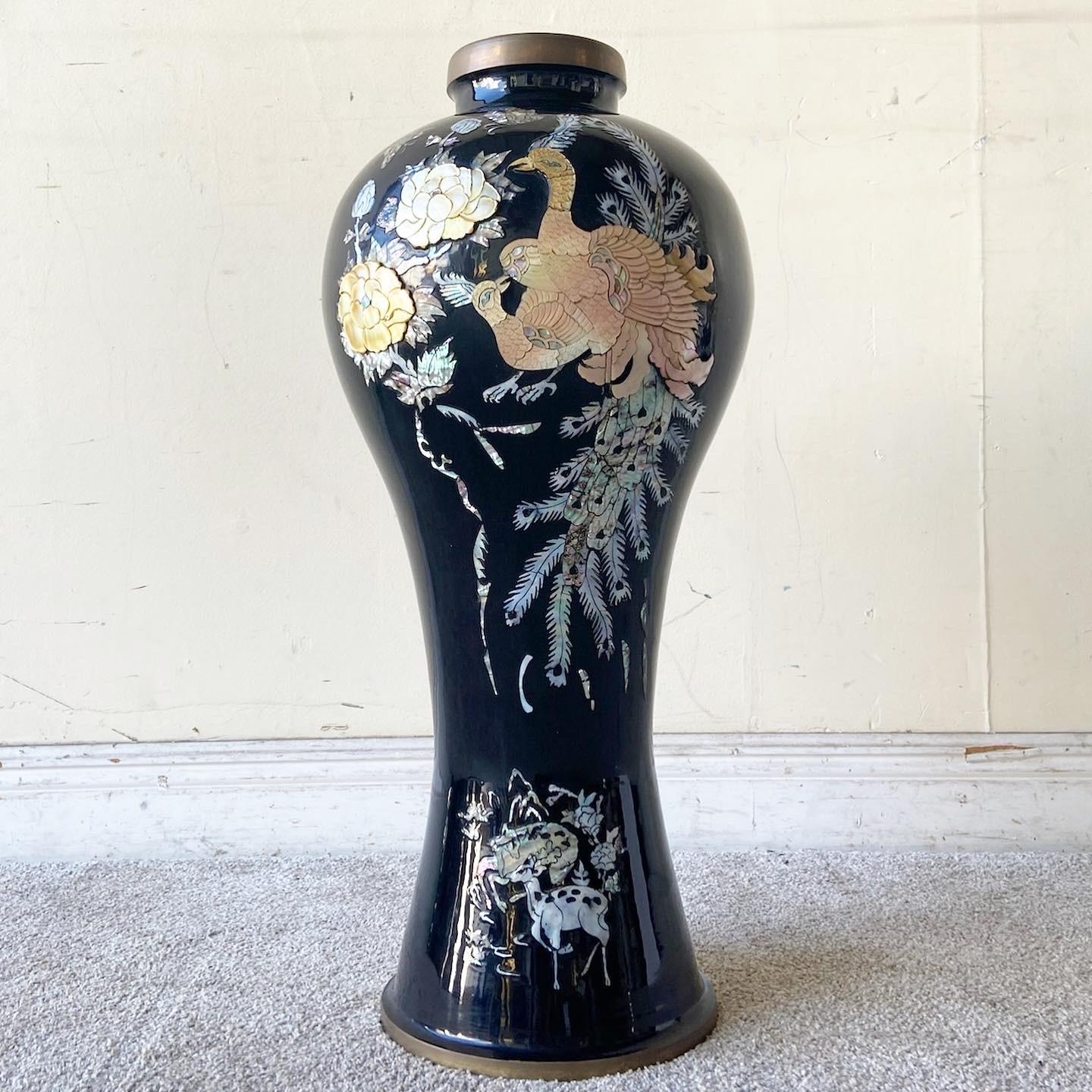 Exceptional vintage chinoiserie brass floor vase. Features a black lacquered finish with an intricate mother of Pearl arrangement depicting peacock birds and flowers. 