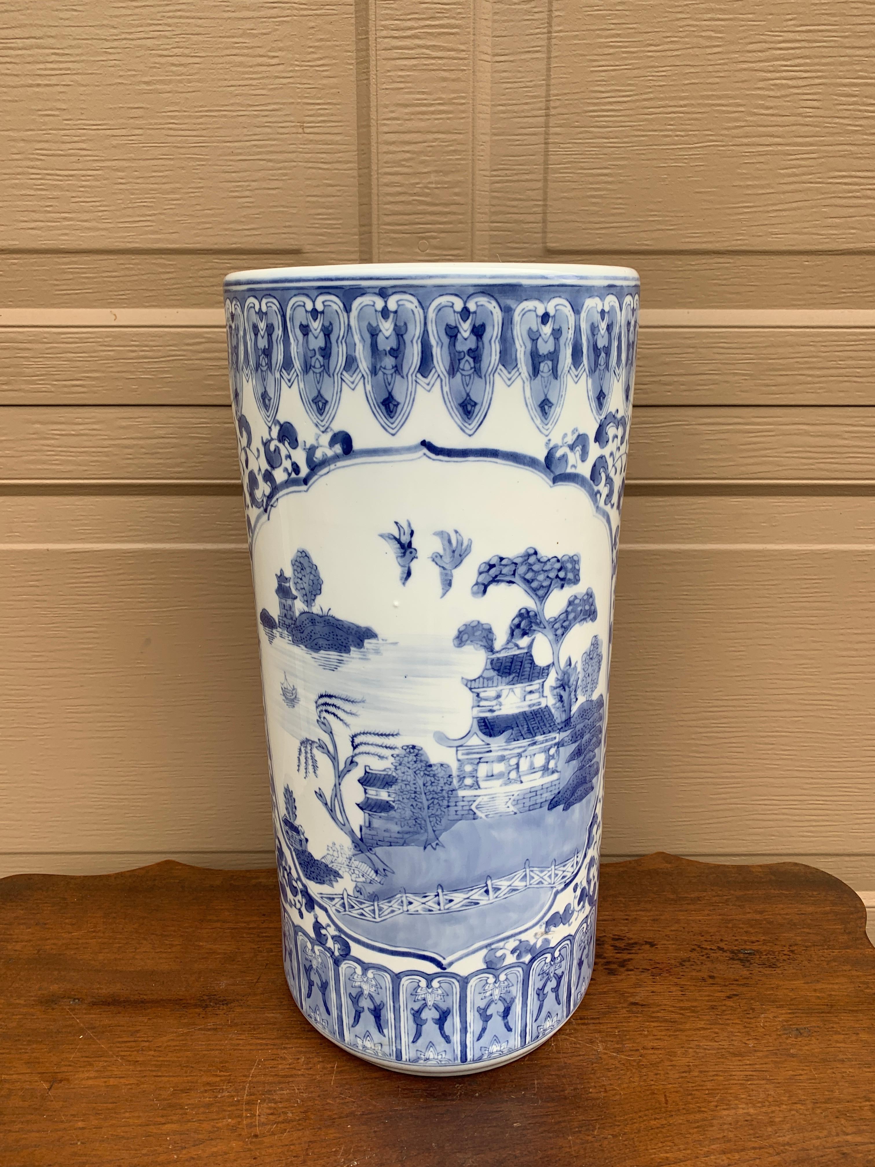 A gorgeous Chinoiserie blue and white porcelain umbrella or cane stand with Asian landscape scenes featuring pagodas

China, Late 20th Century

Measures: 9