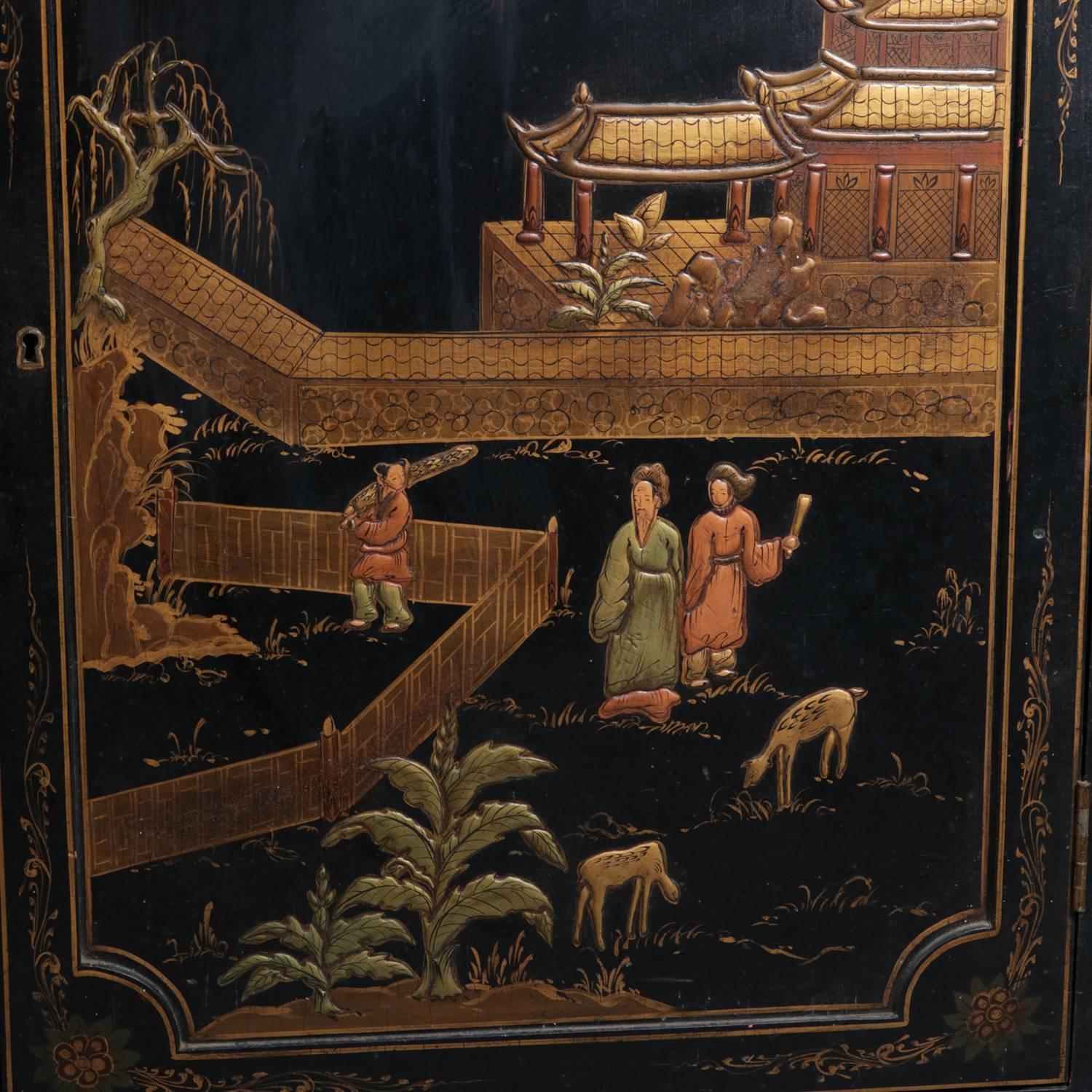 Vintage Chinoiserie two-door credenza features carved and ebonized construction with hand painted and gilt polychrome village farm scenes with villagers, animals and pagoda, gilt floral accents and banding, 20th century.

Measures: 37.5