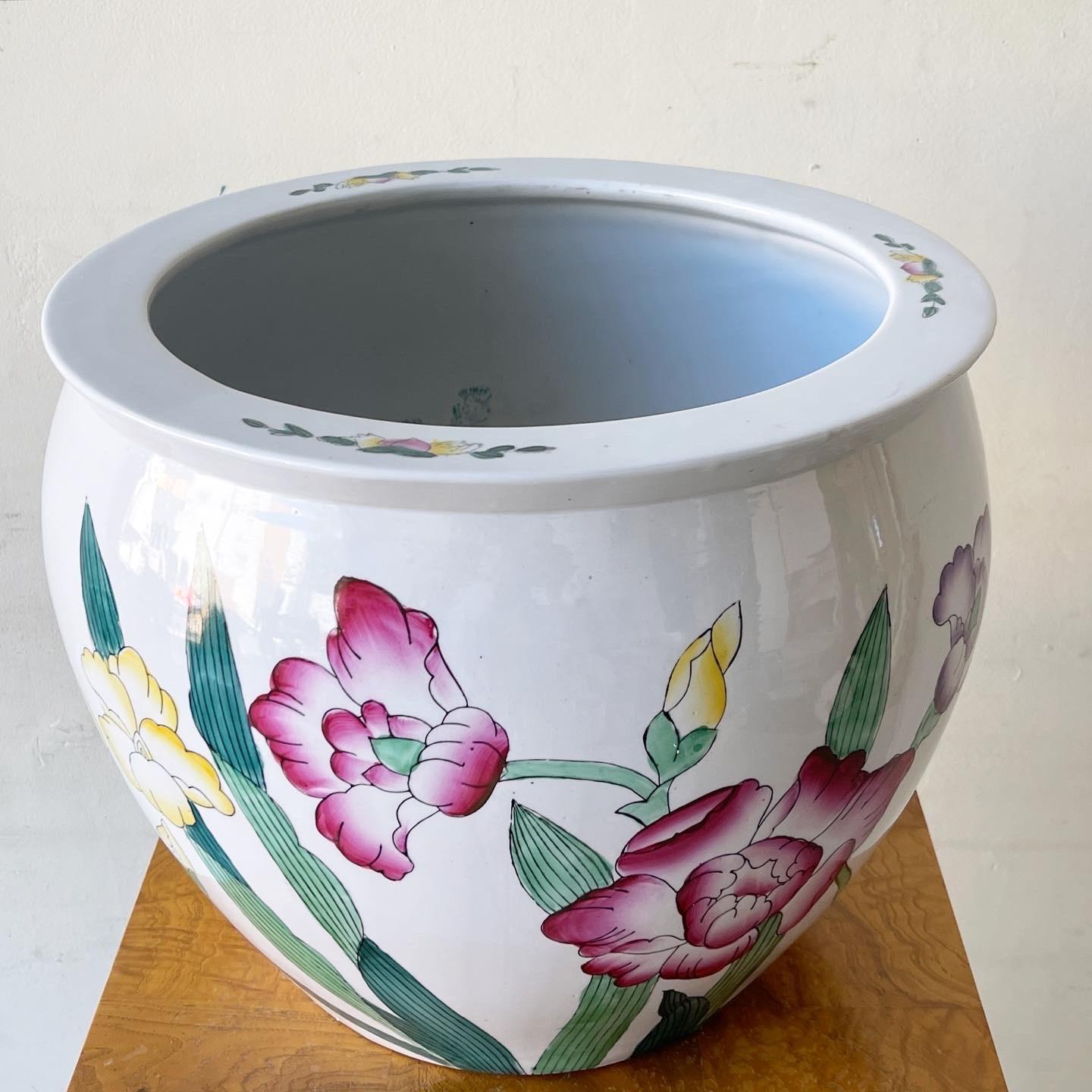 Exceptional vintage chinoiserie planter pot. Features a hand painted display of flowers around the outside with fish painted onto the inside.