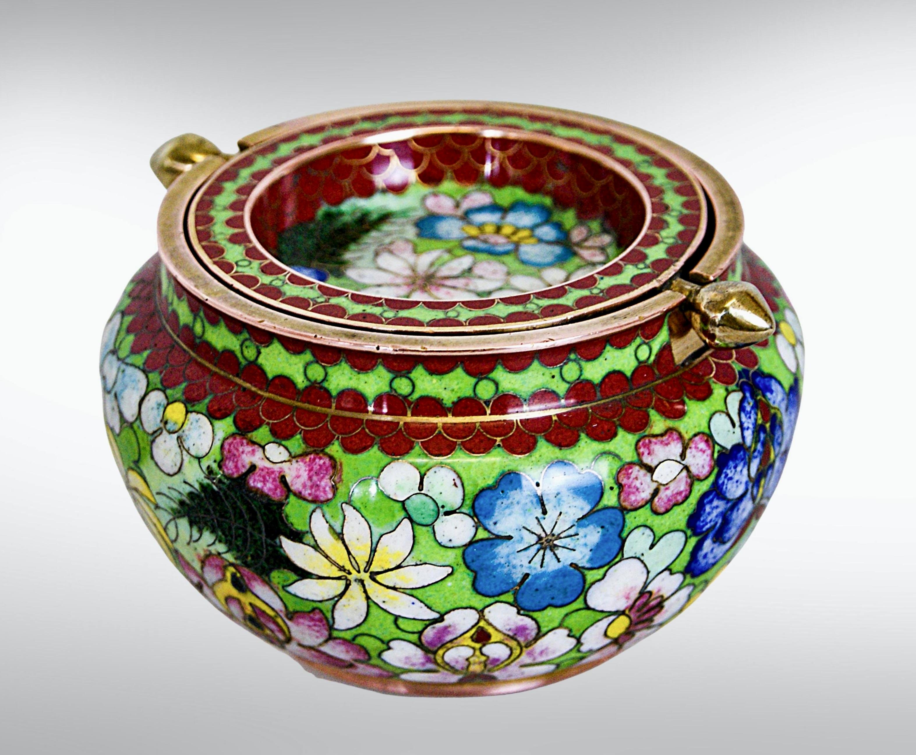 Lovely cloisonné on brass and copper bowl with graduated drop lid.
Hand painted floral enamelled lidded bowl in vibrant colours.
The lid has extended edges with a drop to the rim of the bowl for easy opening and closing. 
With enamelled cobalt