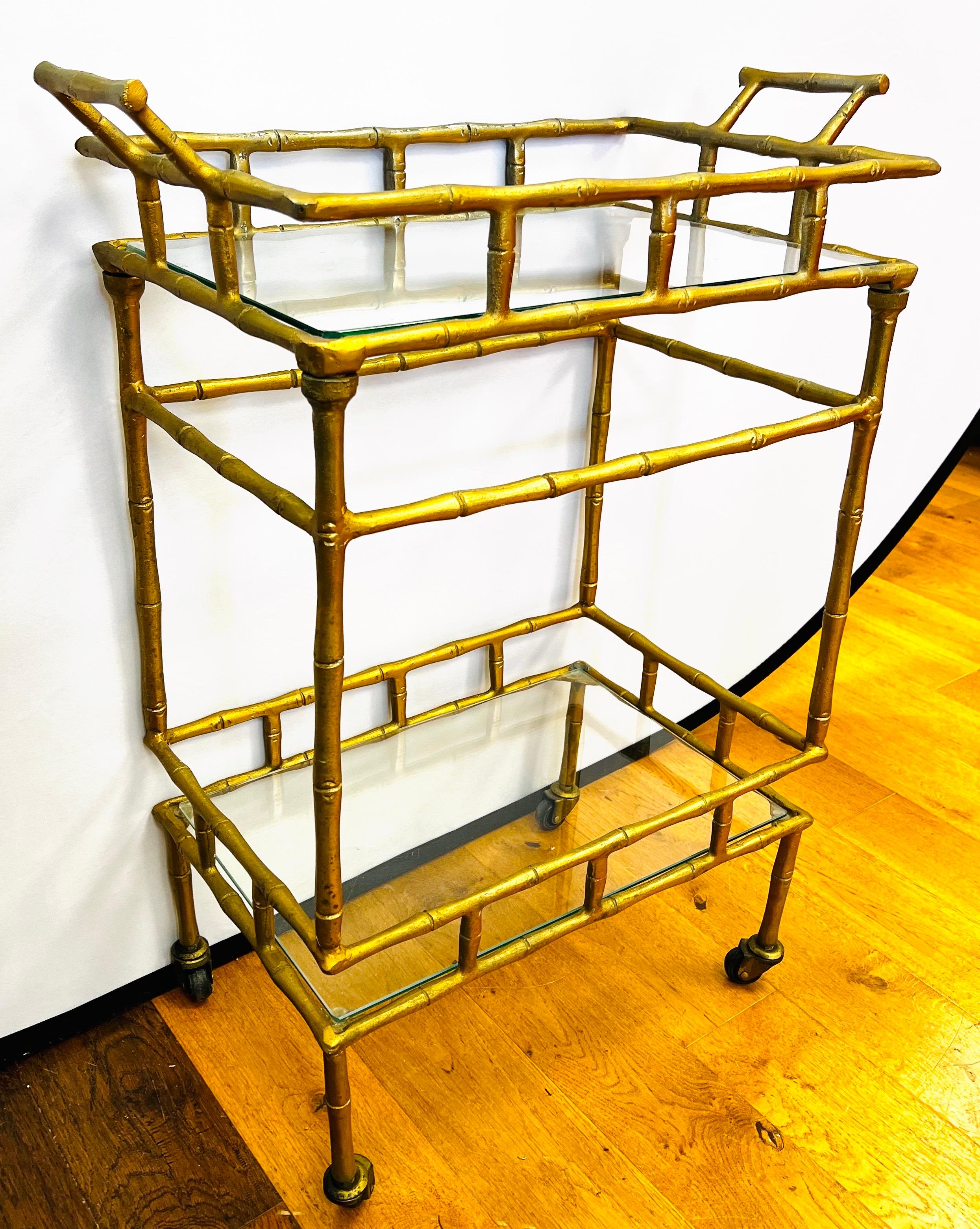 This small gold faux bamboo metal bar cart is the perfect size for any room where you want to entertain your guests. Features glass shelves and wheels. Top tray is removable.
No more getting up to refill your guest’s drinks with this bar cart!