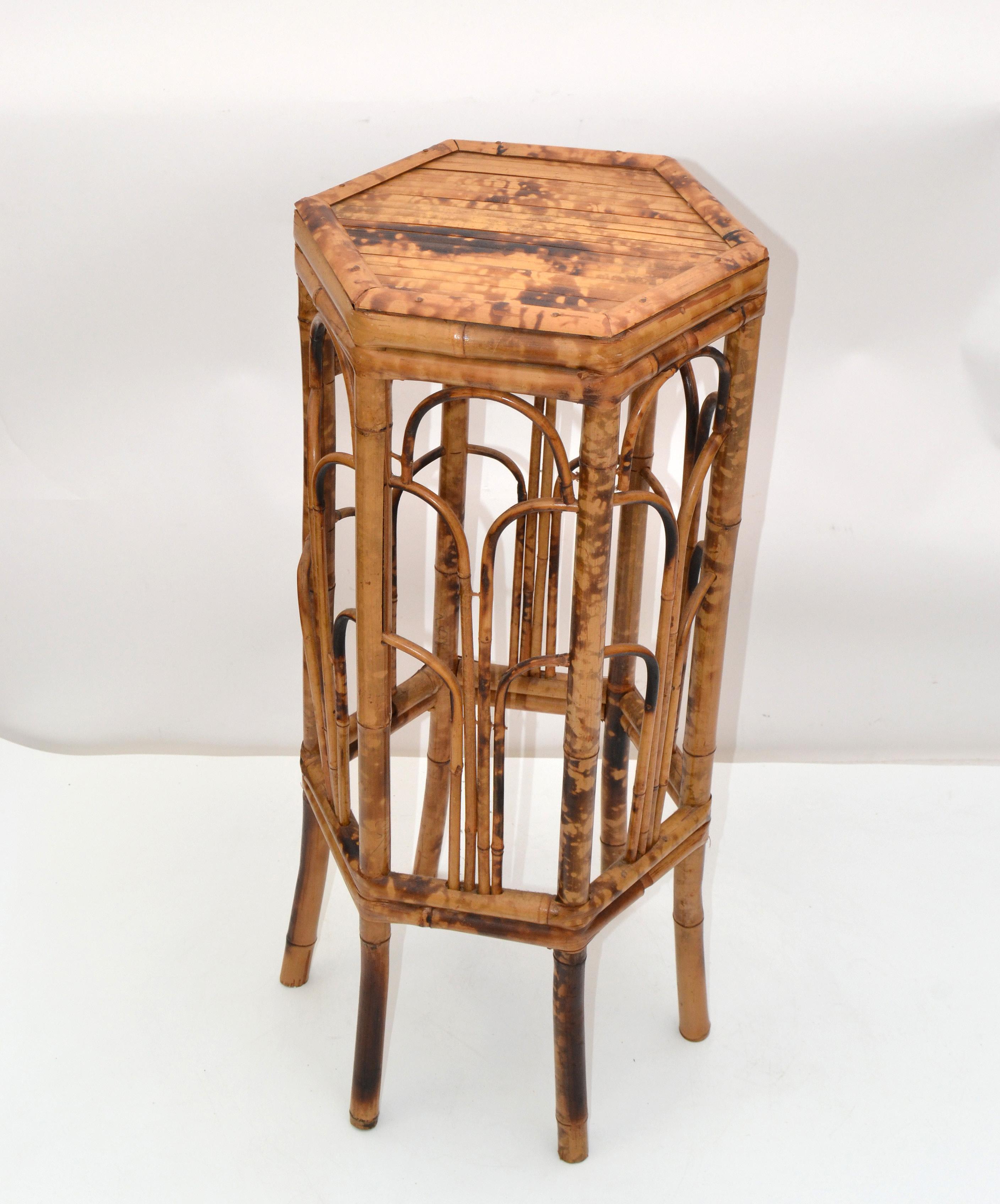 Vintage chinoiserie octagonal shaped bamboo and rattan side table on six legs. 
This table, plant stand is handcrafted with a cane top and features a bamboo frame and Chinese inspired bamboo patterns.
This is a beautiful addition for your