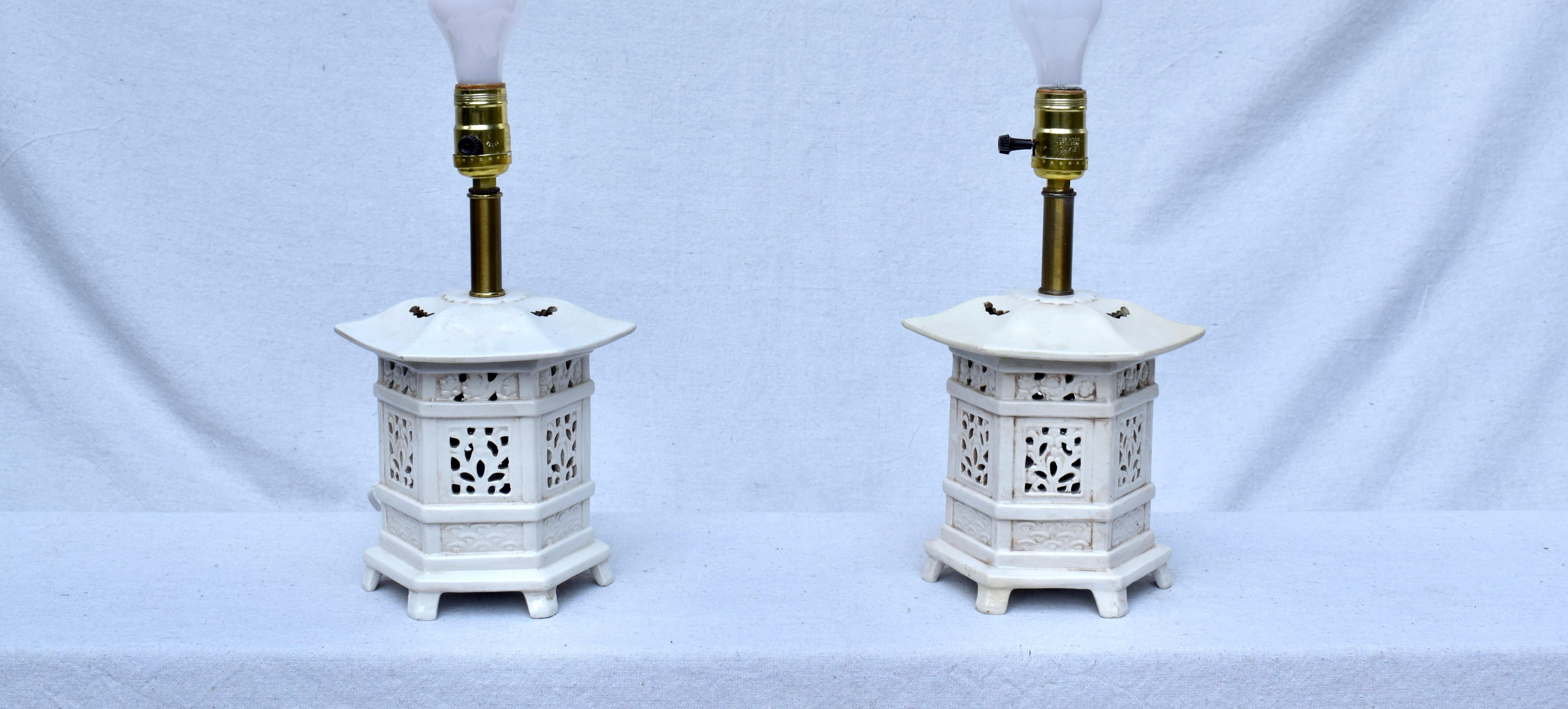 A very sweet pair of Vintage Chinoiserie Pagoda table lamps with custom linen shades. The lamps have been rewired & allow for three ambient lighting options: top tier, lower pierced tier & both tiers. Blanc De Chine styling, circa 1960's Italy,
