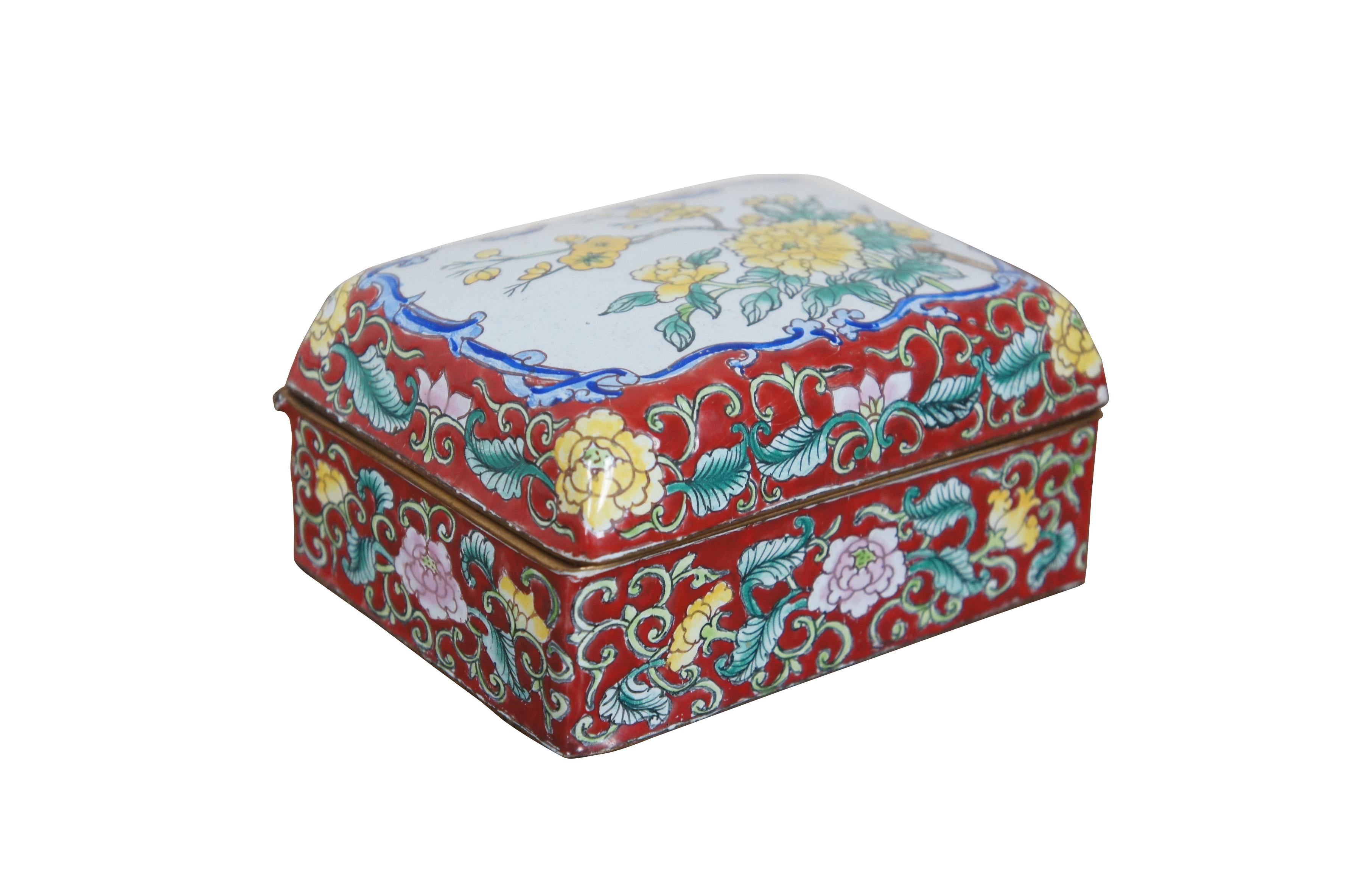 Vintage cloisonne enamel on metal Chinoiserie trinket box. Rectangular form with hinged lid, decorated in red, blue, and white with pink and yellow flowers and swirling leaves.

Dimensions:
4.625