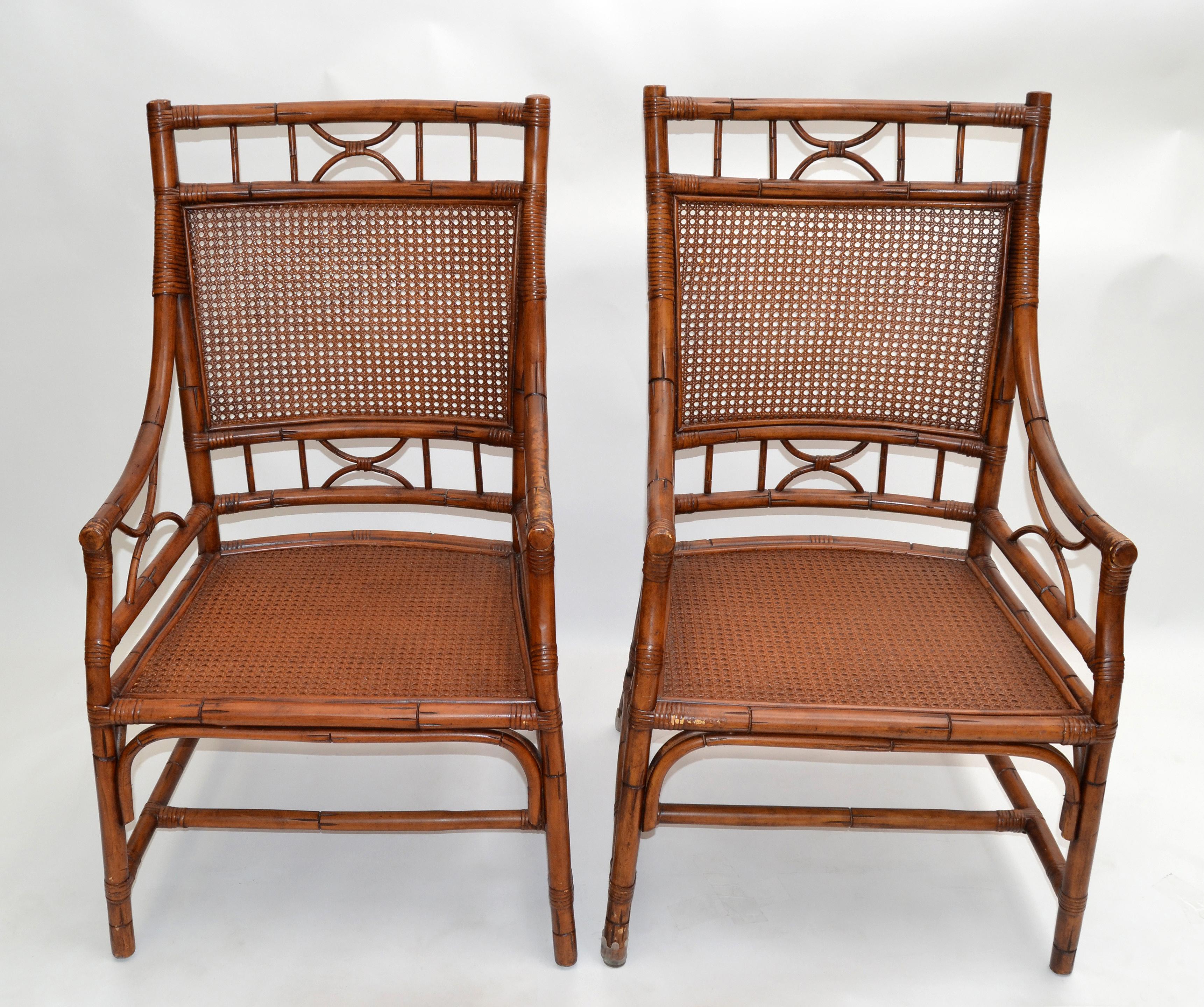 Vintage pair of unique bamboo armchairs. These are handcrafted chairs with cane seats feature bamboo frames and Chinese inspired bamboo patterns. 
The backrests are designed with an extraordinary pattern as shown in the pictures.
This is a beautiful