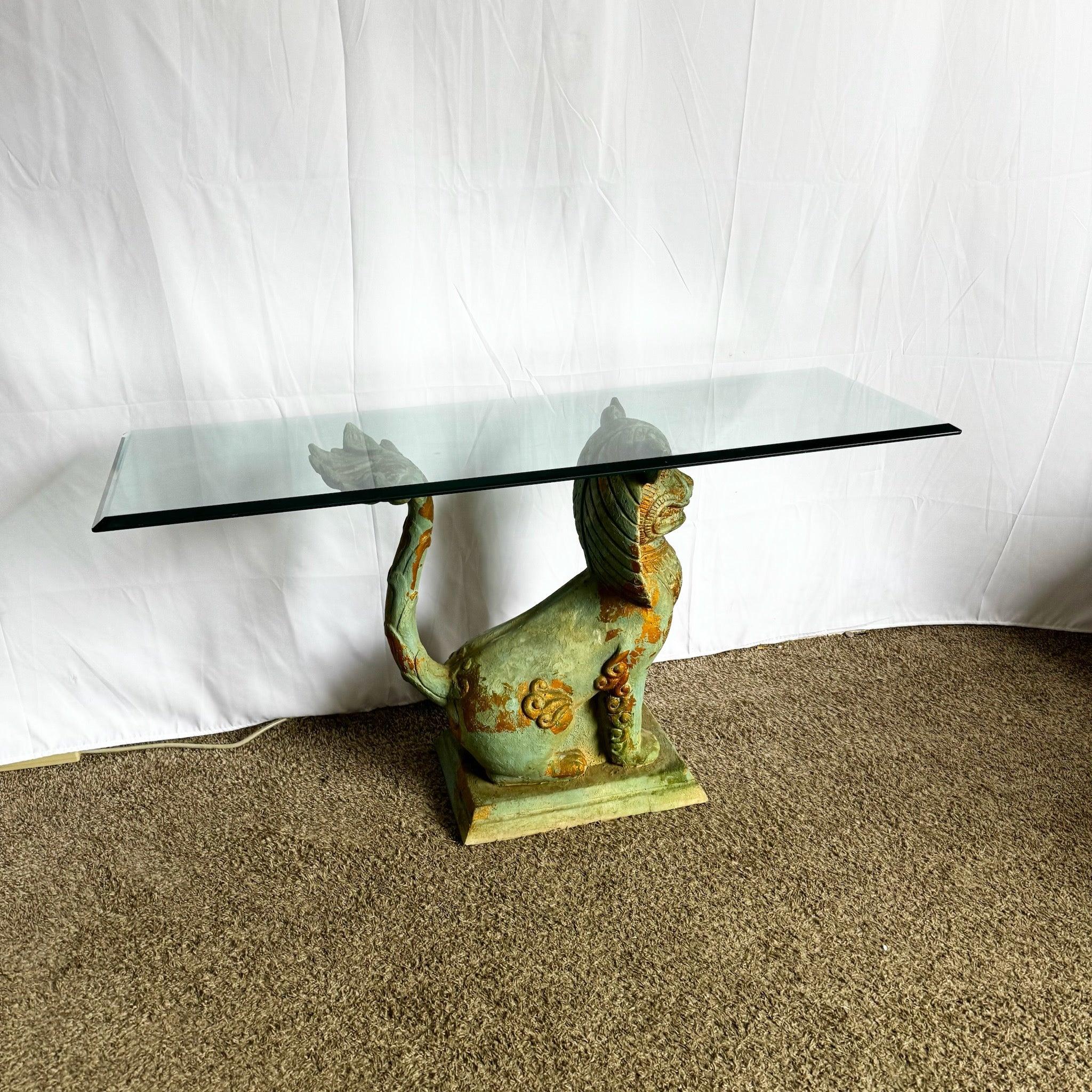 Vintage Chinoiserie Foo Dog Console Table with intricate resin base and glass top, perfect for adding cultural charm and elegance to any space.
 
 Some marks on the back of the dog and a small chip in the glass as shown in the photos.