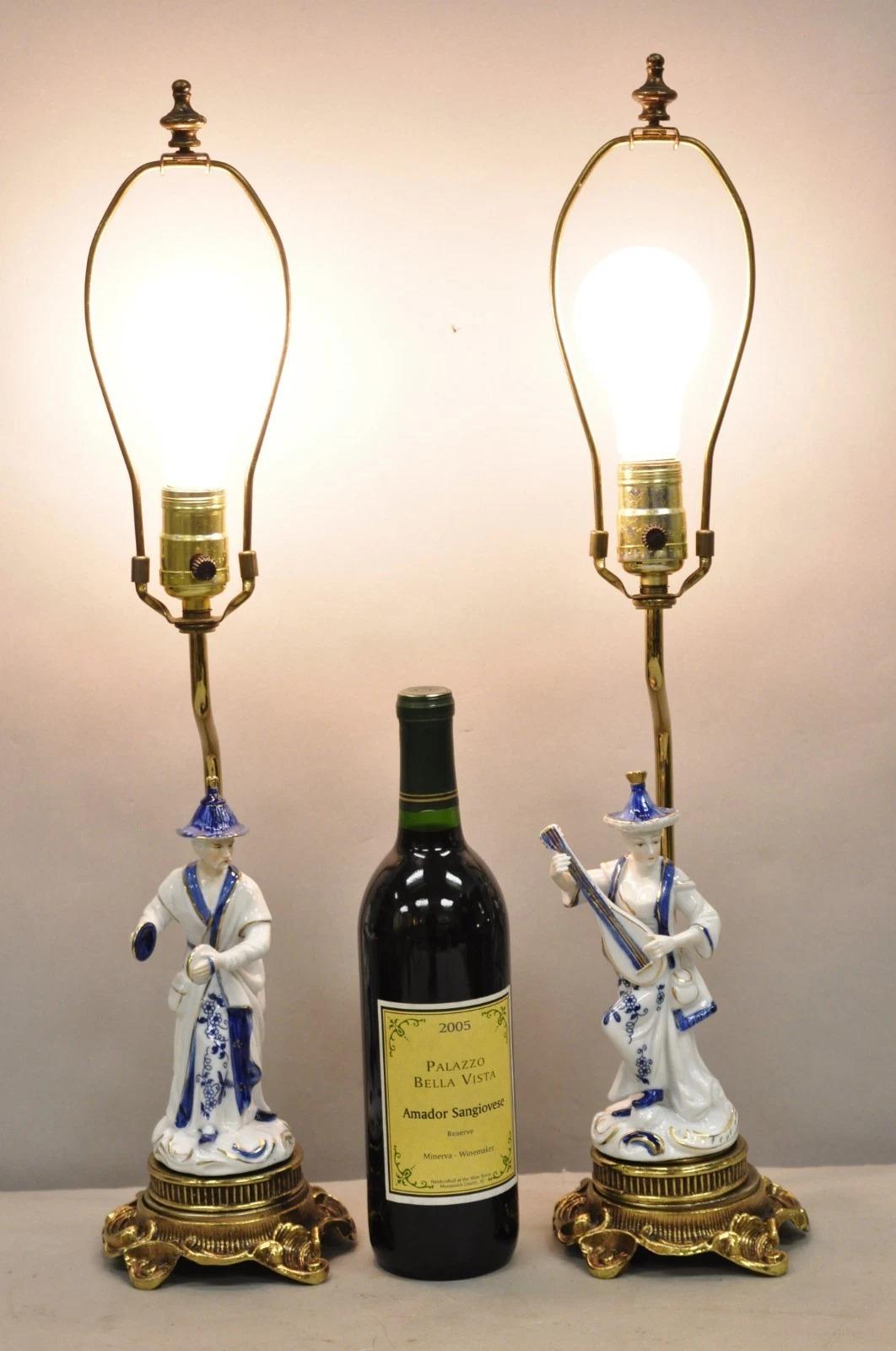 Vintage Chinoiserie Small Figural Porcelain Male & Female Musician Blue & White Brass Oriental Table Lamps - a Pair. Circa Mid 20th Century. Measurements: 23.5