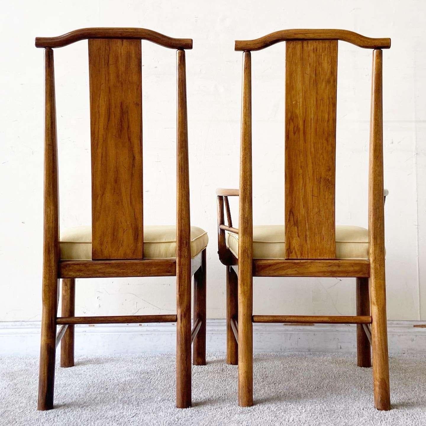 Vintage chinoiserie wooden dining chairs. The seat features two captains chairs and 4 side chairs with a light yellow fabric seat cushion.

Armchairs have a width of 22.5”

Seat height is 19.0 in