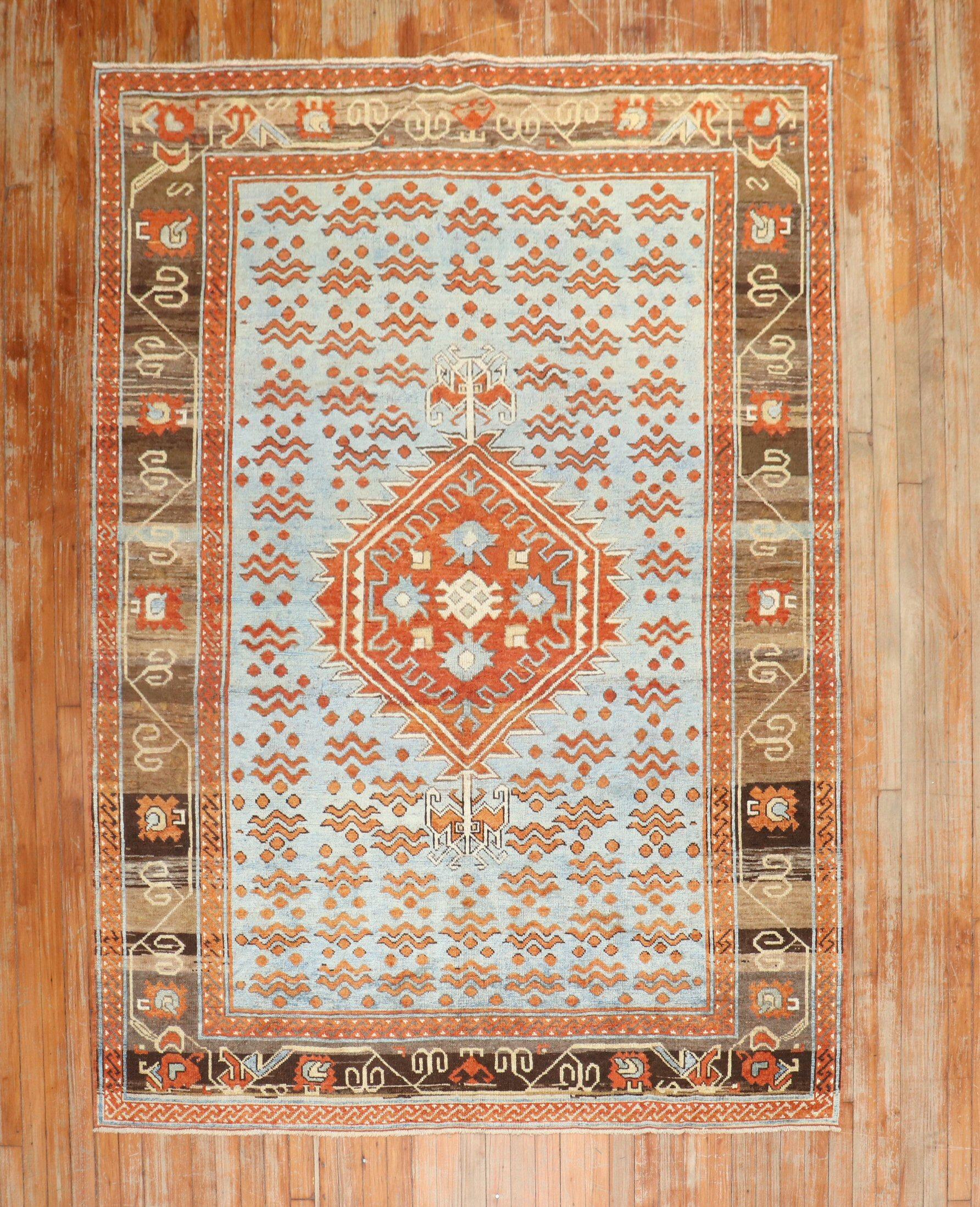 An obscure east Turkestan rug from the 3rd quarter of the 20th century featuring a Chintamani motif on an blue field.

5'9'' x 7'8''