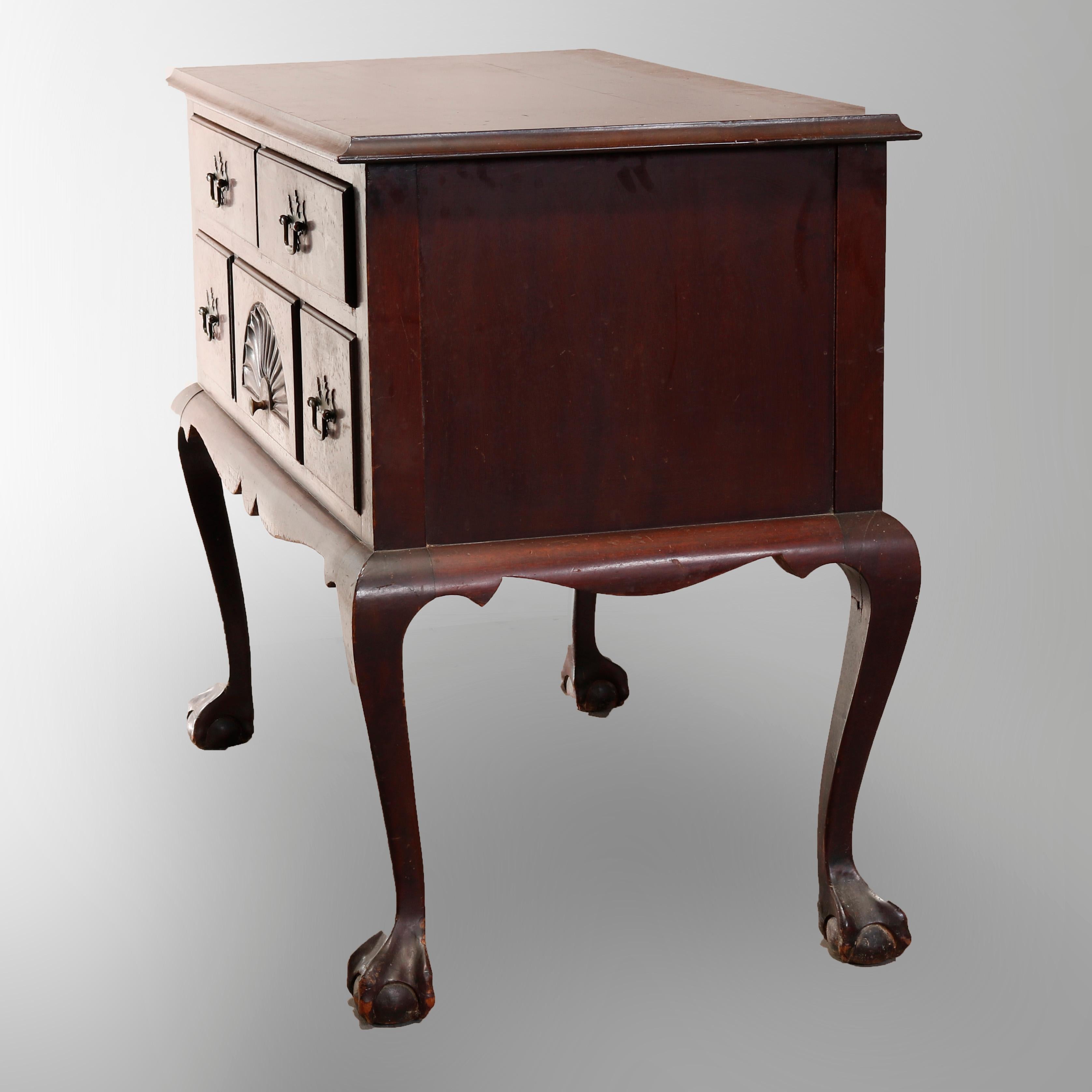 A vintage Chippendale style lowboy in the manner of Baker offers mahogany construction with case having drawers with central carved shell and shaped skirt, raised on cabriole legs terminating in stylized claw and ball feet, 20th century

Measures: