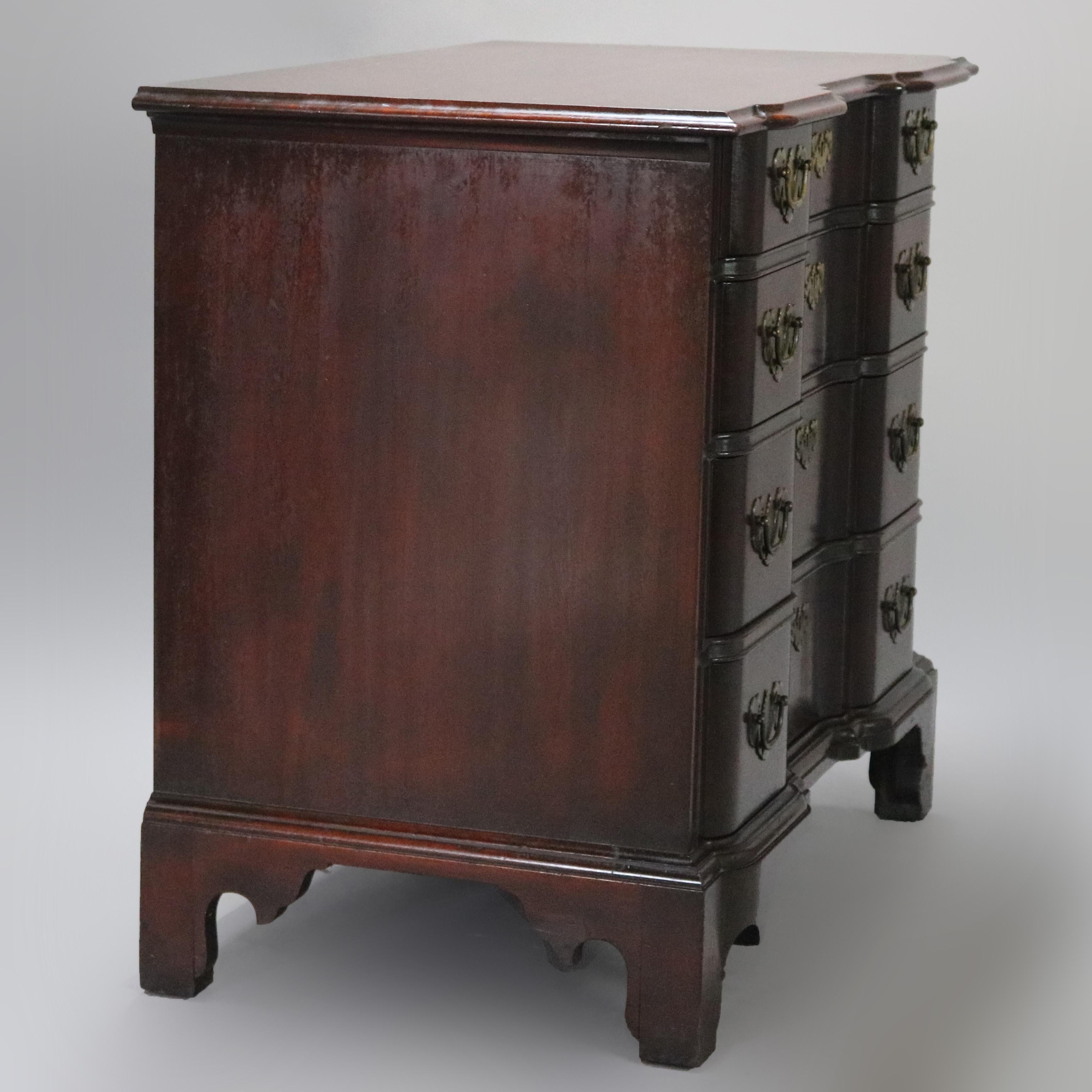 A vintage Chippendale Baker style block front butler's chest of drawers overs mahogany construction with four graduated doors, bat wing brass hardware and raised on bracket feet, 20th century

Measures: 31.25