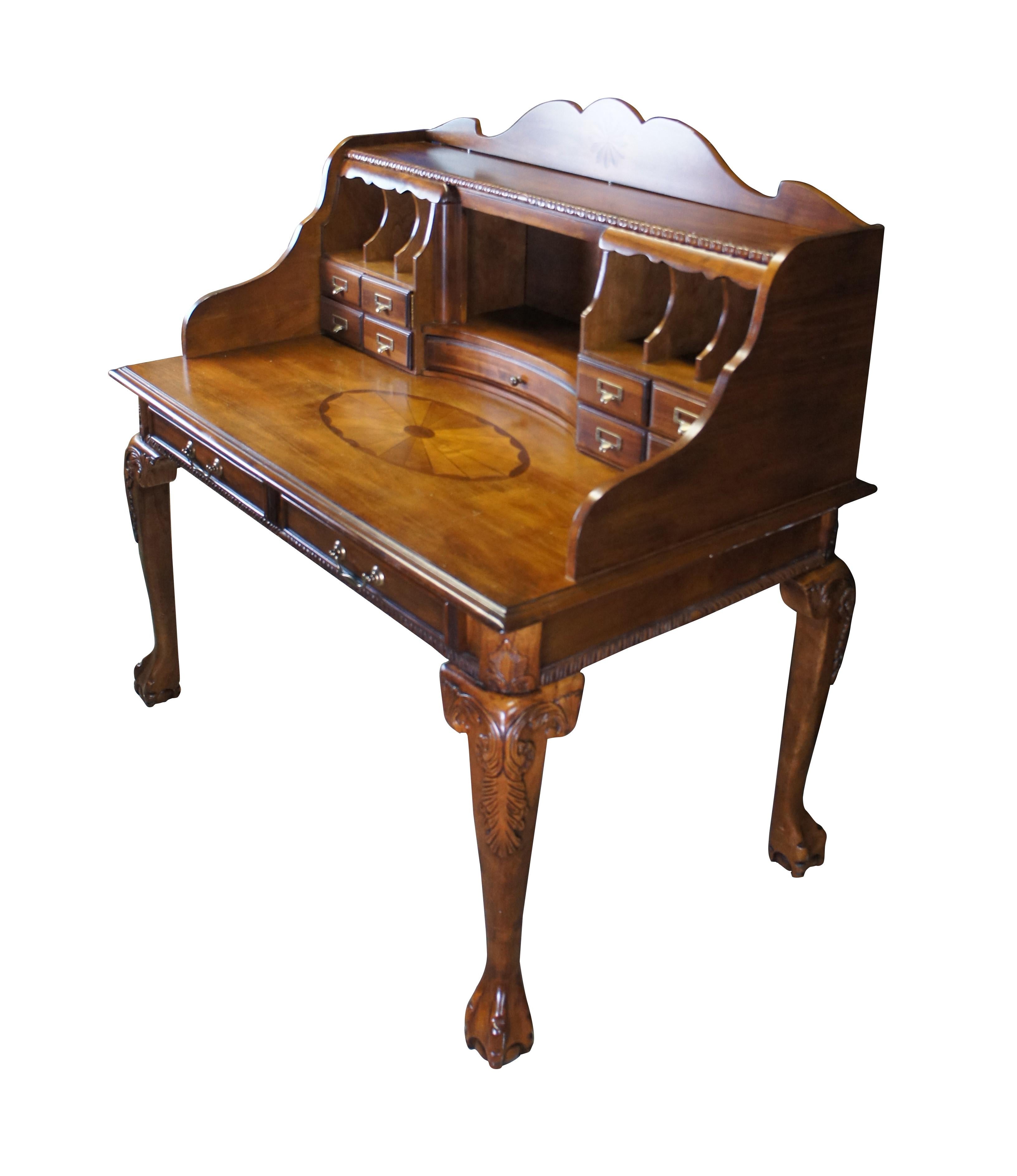 Vintage Chippendale style secretary library writing desk.  Made of brown cherry featuring inlaid and carved designs with multiple drawers, cubbies, and ball & claw feet.  Glen Eagle H217-27.

Dimensions:
50