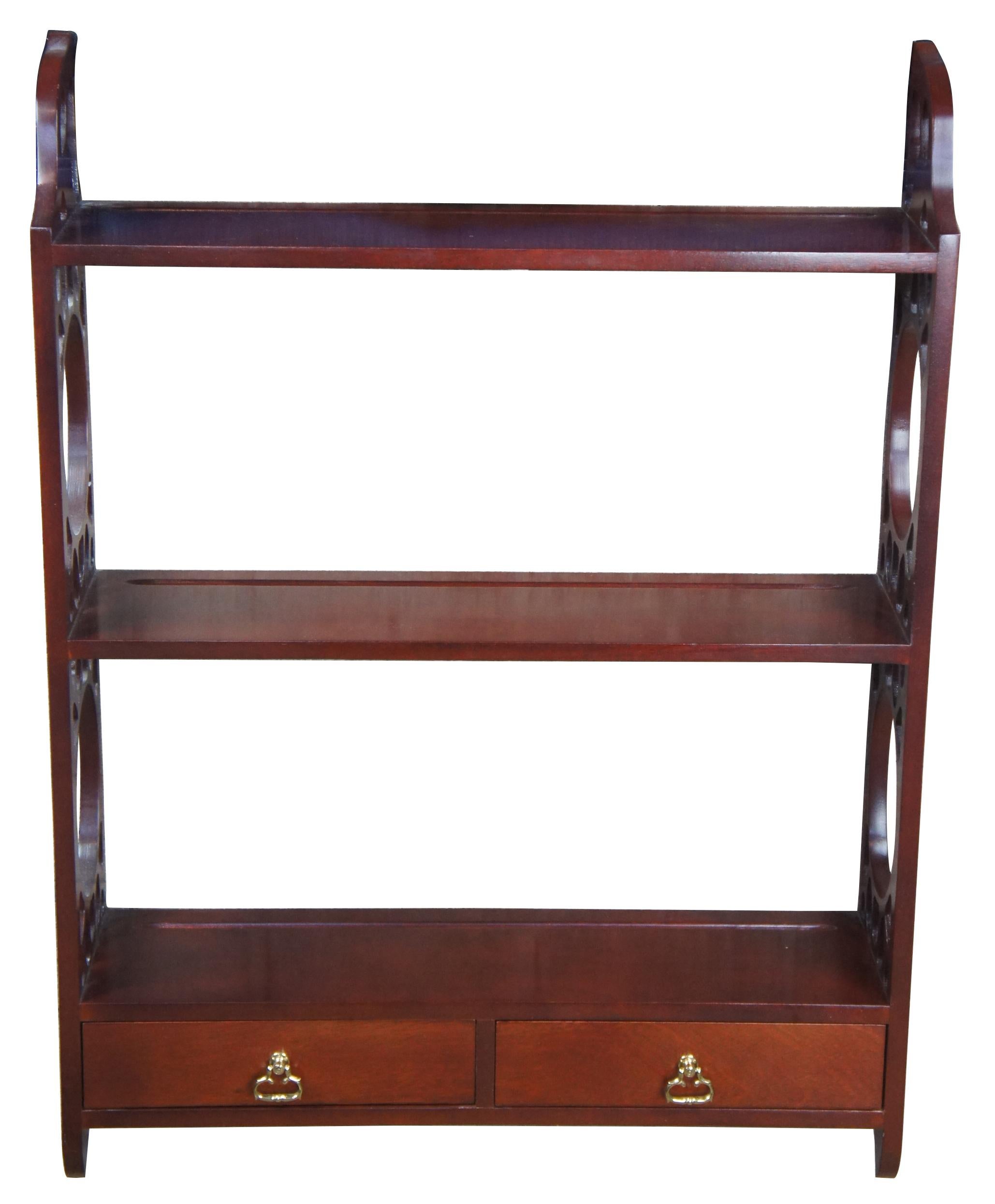 Chippendale style cherry wall shelf or plate rack. Featuring three shelves connected by twin fret work supports. Includes two drawers at the base. Attributed to Henkel Harris. Measures: 35