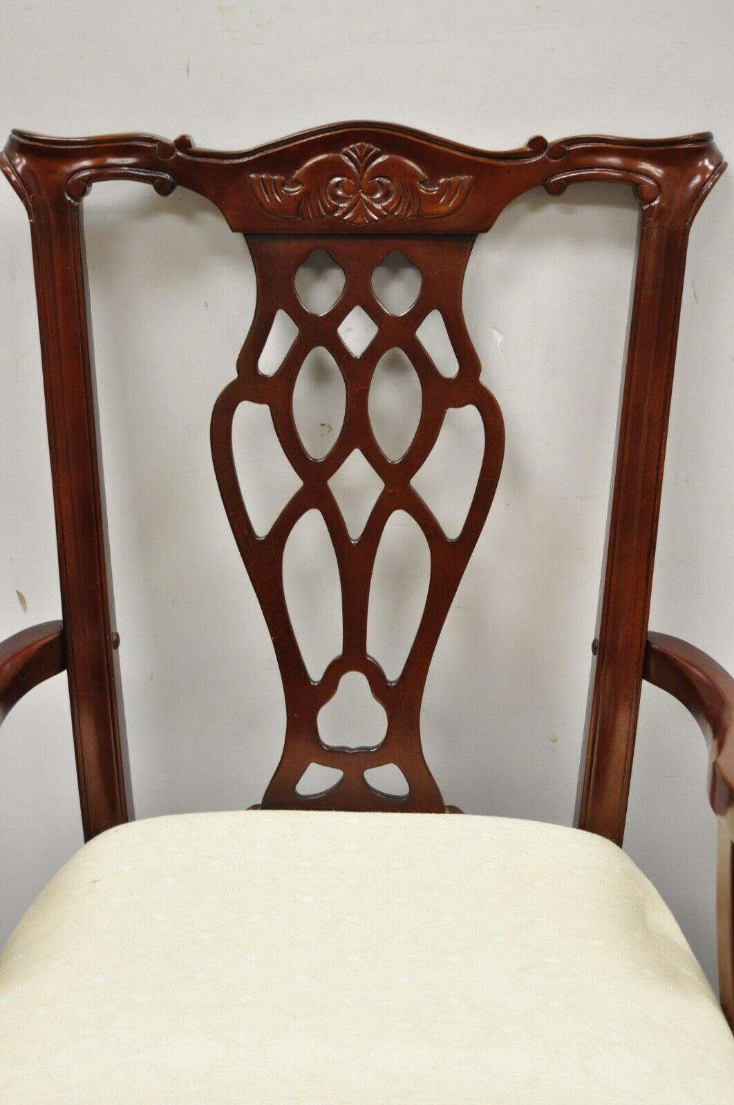 Vintage Chippendale style cherry wood dining arm chairs by Master Design - a pair. Item features beautiful wood grain, upholstered seat, nicely carved details, original label, craved ball and claw feet, great style and form. Circa 1990s, Canada.