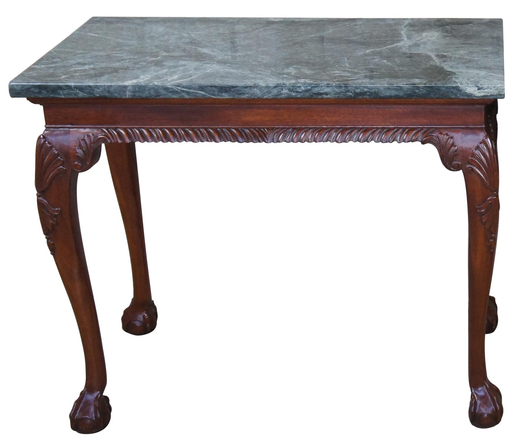 A lovely Chippendale style console table. Made from mahogany with carved legs and gadrooned aprons. Feature green marble tops, ball and claw feet and shell carved legs. A stately addition to any entryway or hallway.
   