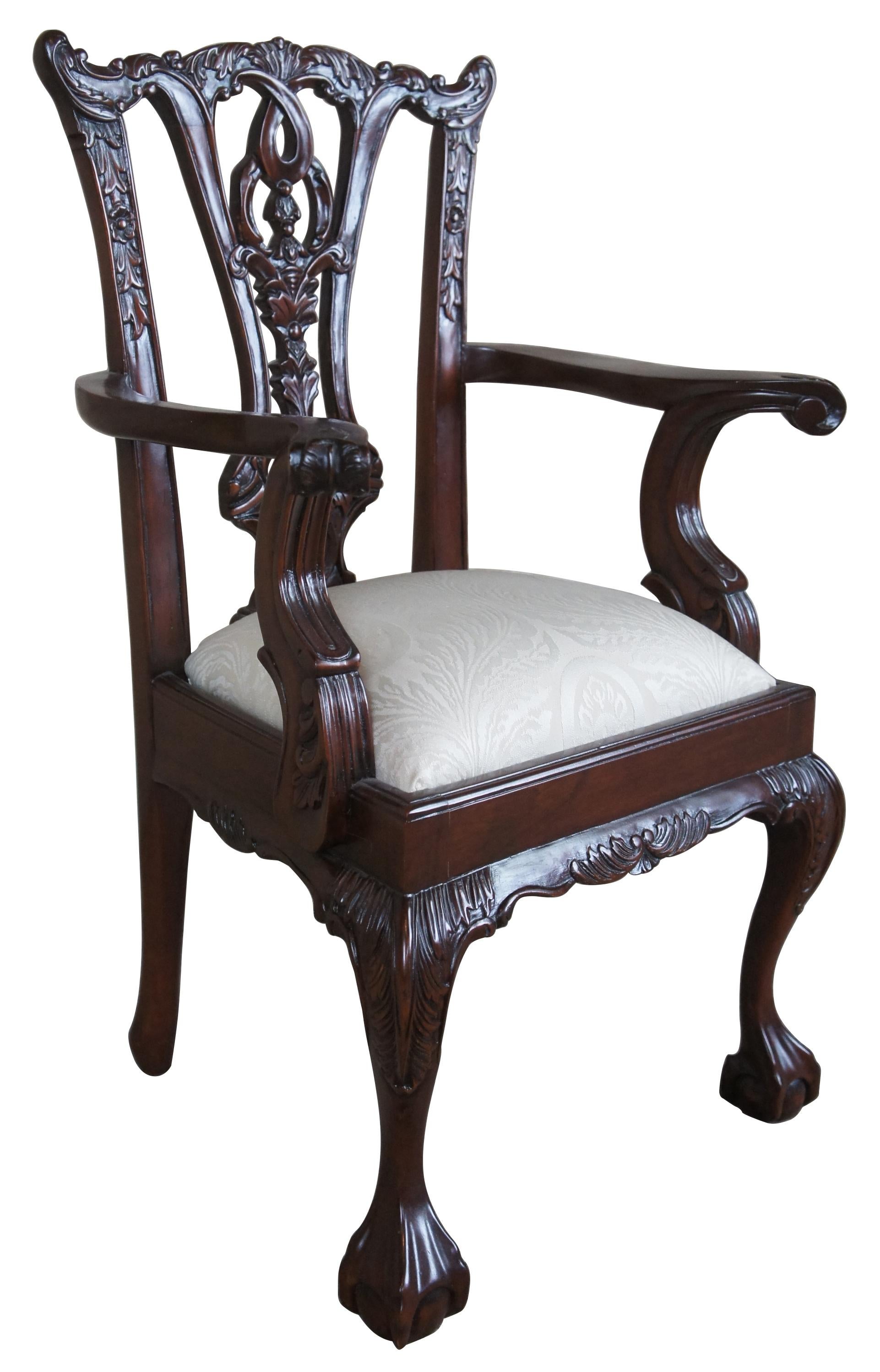 Late 20th century Chippendale child or dolls chair. Made exclusively for Georgian Furnishing Co., LTD. in New Orleans, LA. Made from Mahogany with an intricately carved crest and rail over pierced splat. Upholstered in a white French fabric. The
