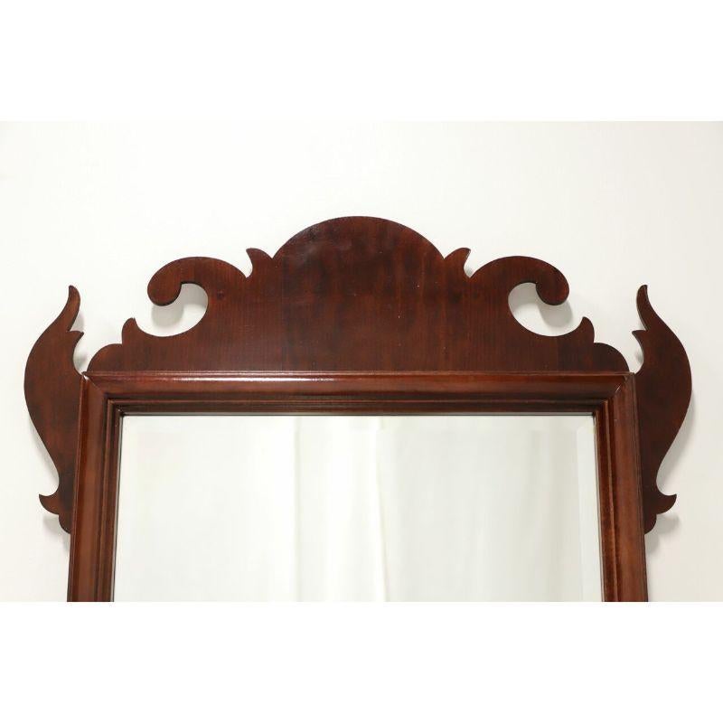 A Chippendale style wall mirror, unbranded. Mirrored glass in a mahogany frame with decorative carving to top and bottom. Made in the USA, in the late 20th century.

Measures: 25 W 1.5 D 41.75 H, Weighs Approximately: 15 lbs

Exceptionally good