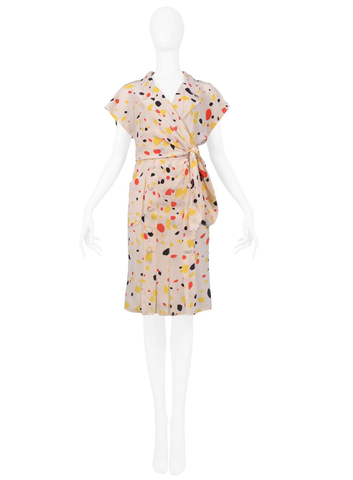 Vintage Chloe silk dress with yellow, black, and red abstract polka dot print. This dress features a wrap-style top and pleated skirt with side pockets and double button detail on front.

Excellent Vintage Condition

Size: No Size Label. Will fit a